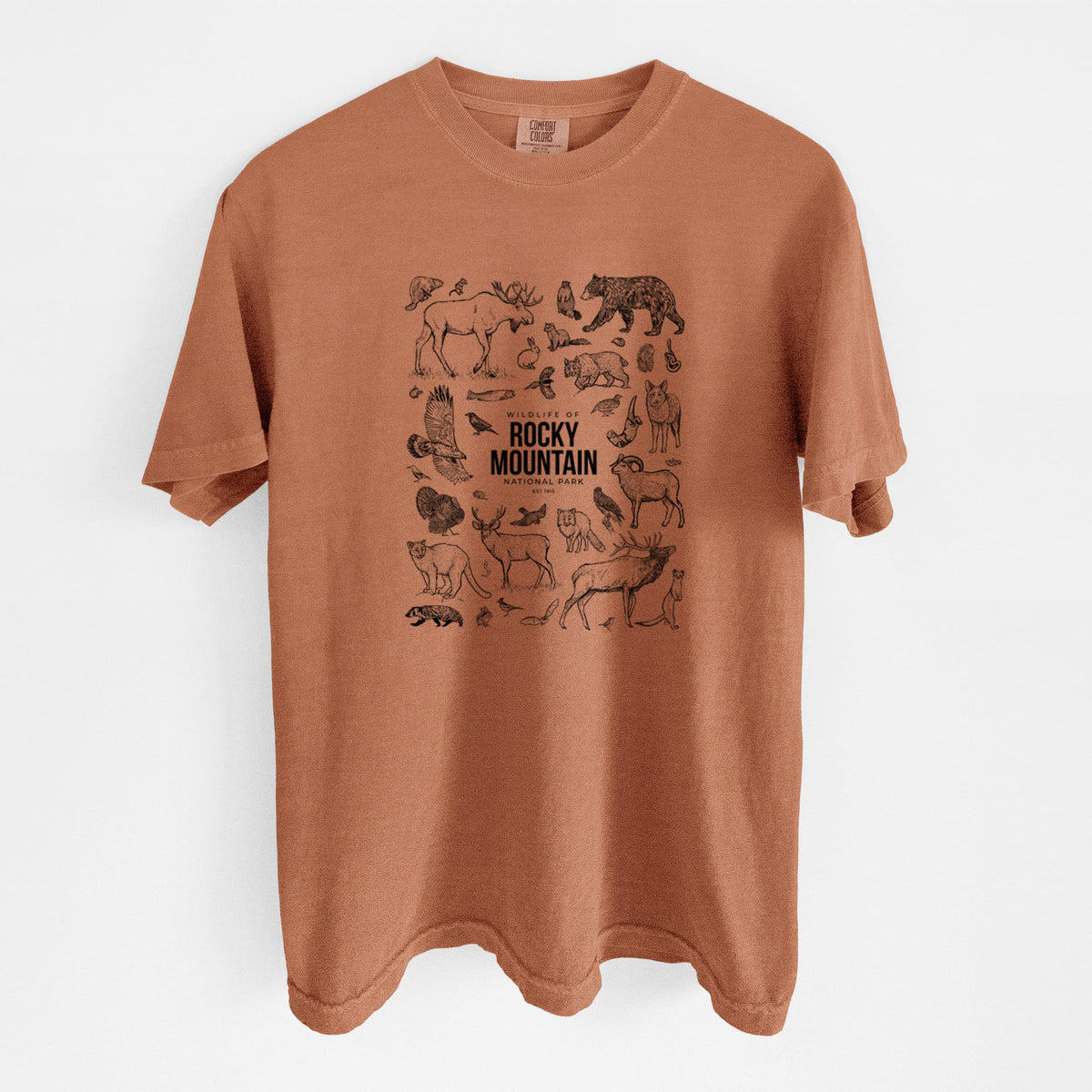 Yam burnt orange Comfort Colors t-shirt laid flat, printed with a collection of black ink wildlife illustrations surrounding the words Rocky Mountain National Park.