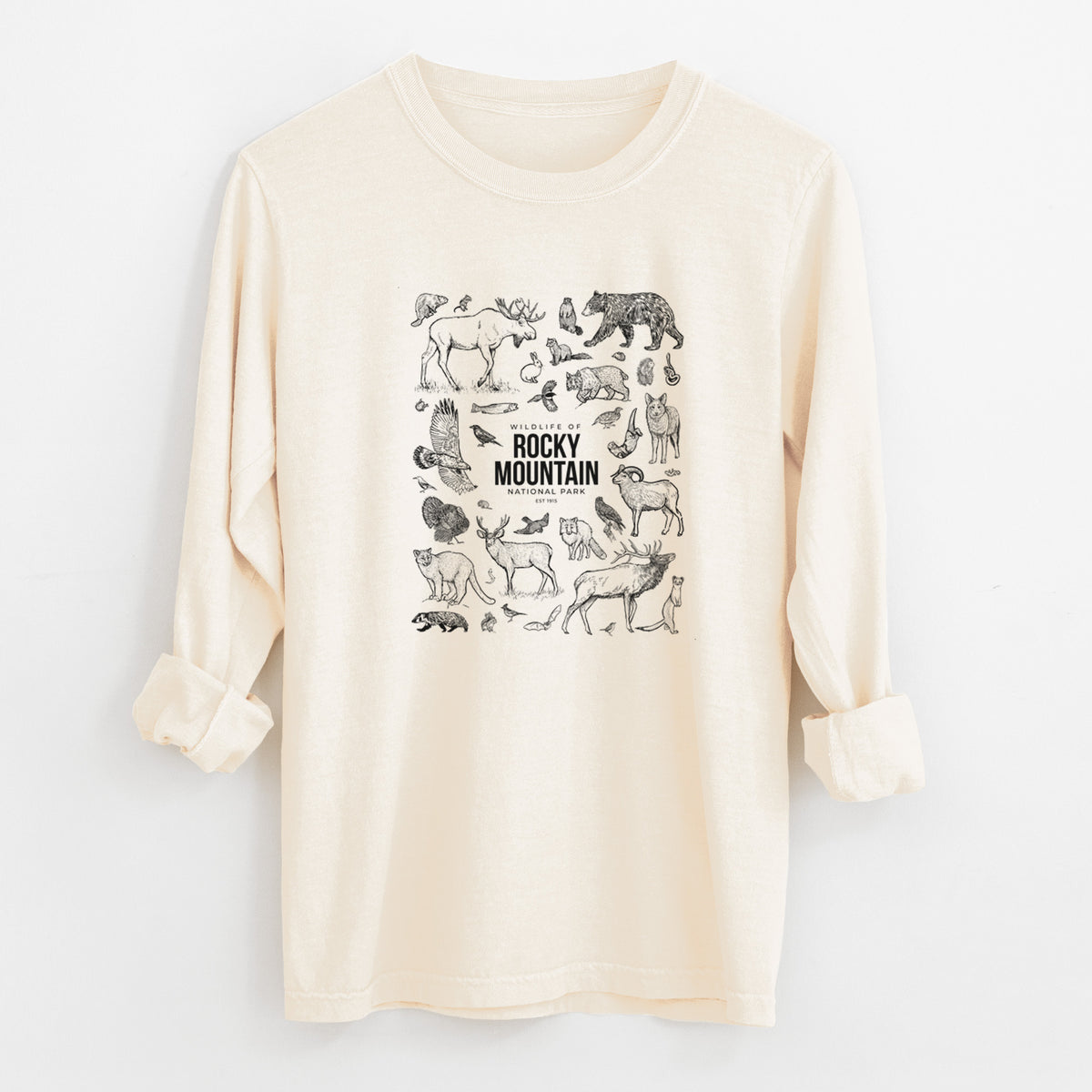 Ivory Comfort Colors long sleeve shirt laid flat with the cuffs rolled, printed with a collection of black ink wildlife illustrations surrounding the words Rocky Mountain National Park.