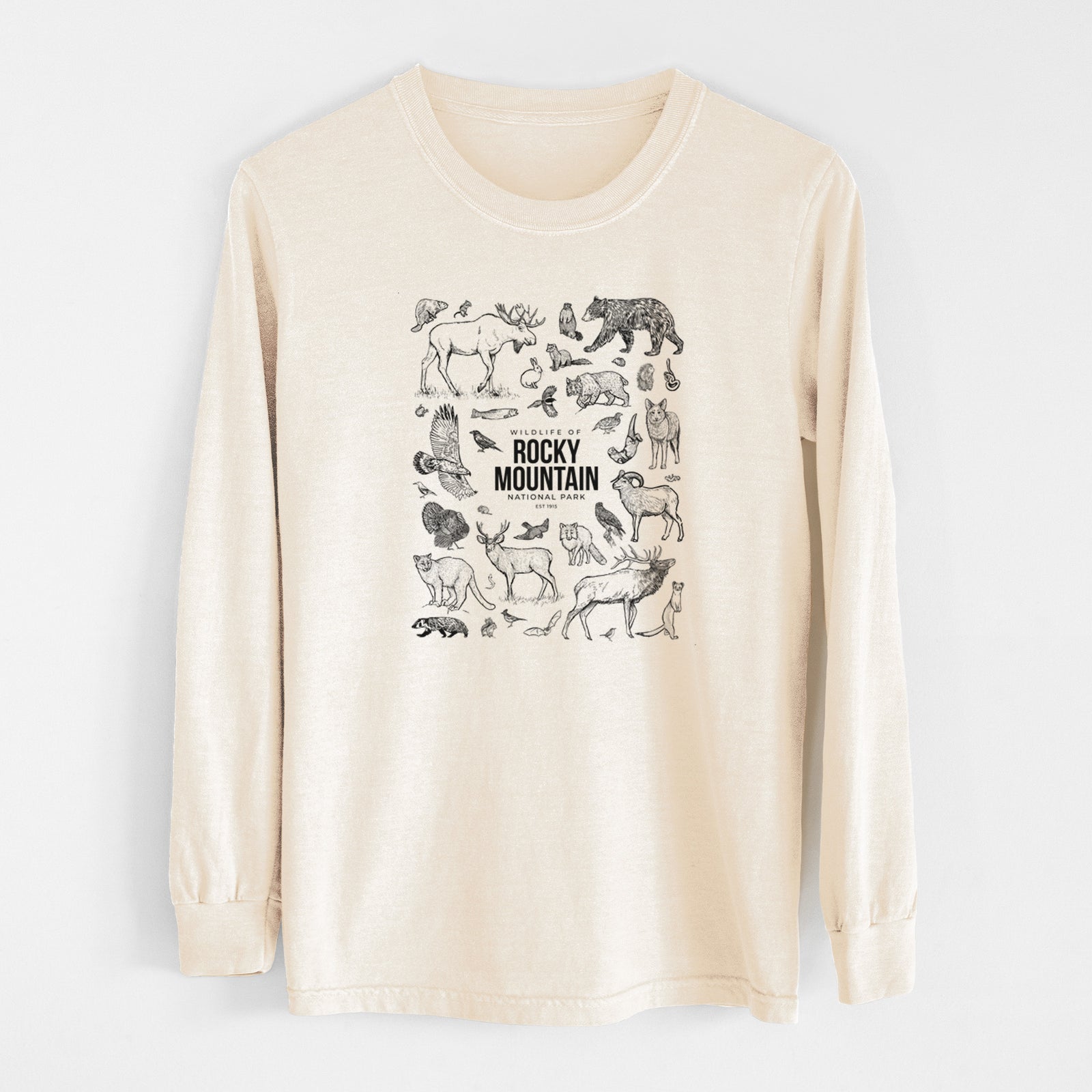 Ivory Comfort Colors long sleeve shirt laid flat, printed with a collection of black ink wildlife illustrations surrounding the words Rocky Mountain National Park.