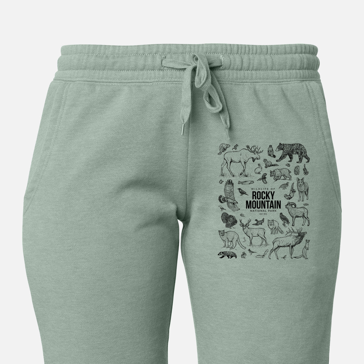 Front of sage green Cali Wave sweatpants, printed with a collection of black ink wildlife illustrations surrounding the words Rocky Mountain National Park on the leg.