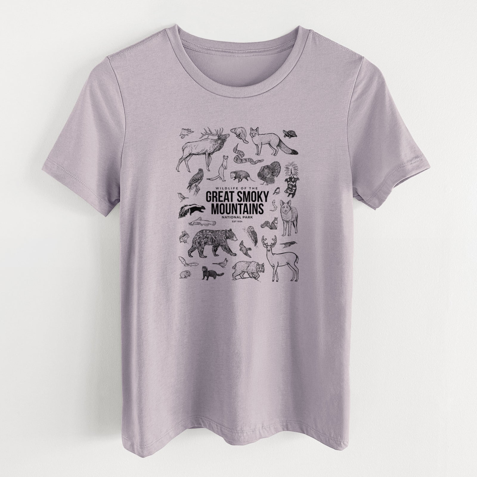 Light violet women's relaxed fit cotton t-shirt laid flat, printed with a collection of black ink wildlife illustrations surrounding the words Great Smoky Mountains National Park.