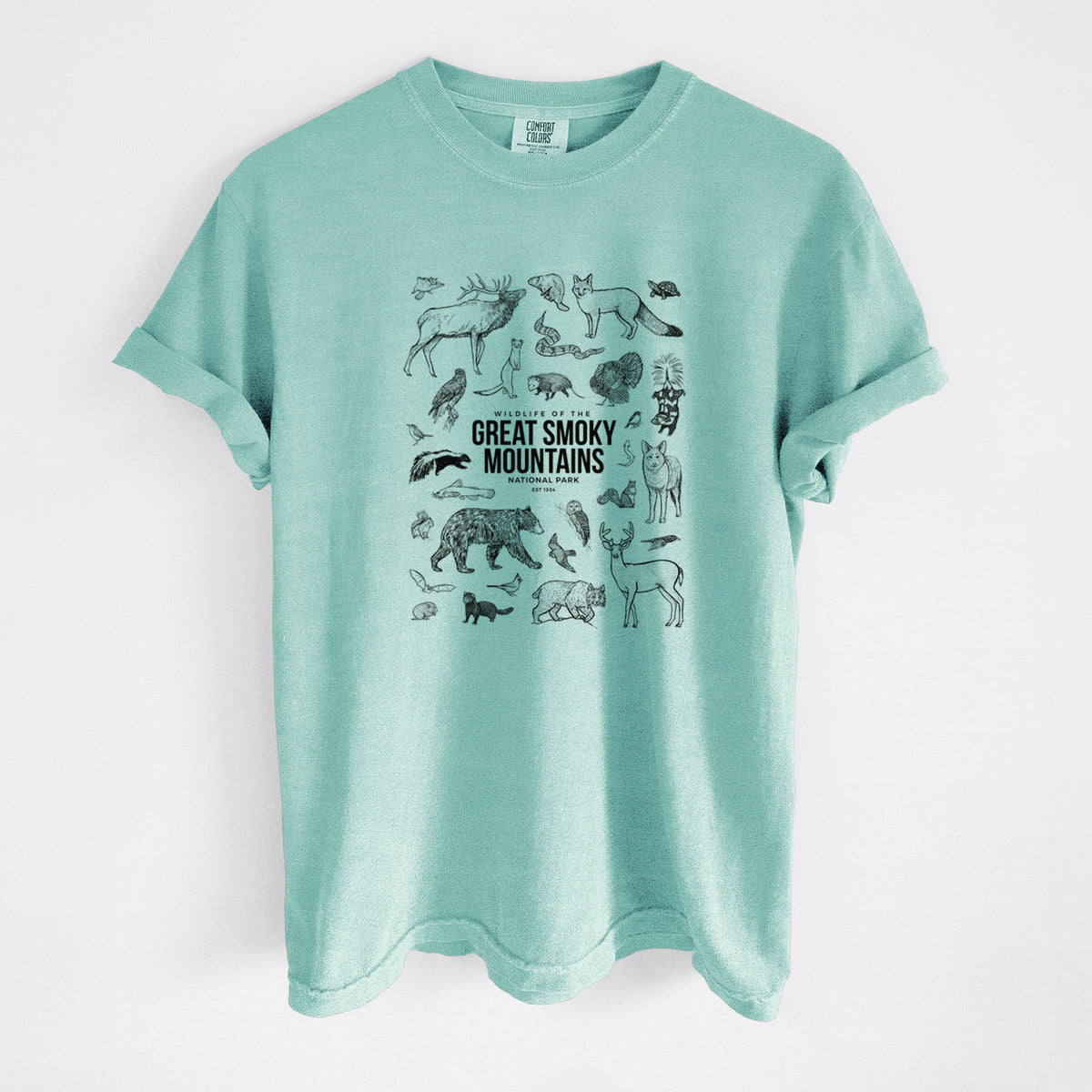 Chalky mint Comfort Colors t-shirt laid flat, printed with a collection of black ink wildlife illustrations surrounding the words Great Smoky Mountains National Park.