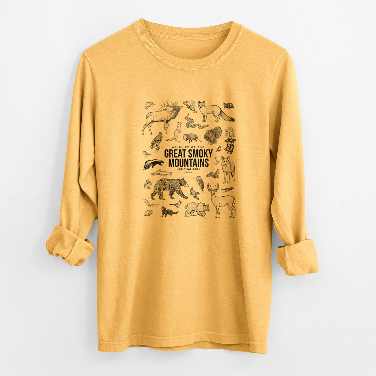 Golden wheat yellow Comfort Colors long sleeve shirt laid flat with the cuffs rolled, printed with a collection of black ink wildlife illustrations surrounding the words Great Smoky Mountains National Park.
