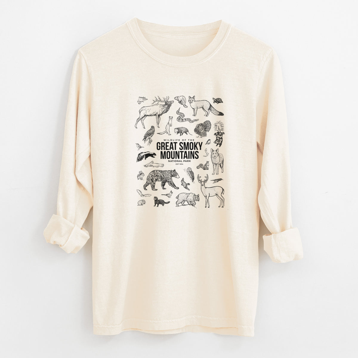 Ivory Comfort Colors long sleeve shirt laid flat with the cuffs rolled, printed with a collection of black ink wildlife illustrations surrounding the words Great Smoky Mountains National Park.