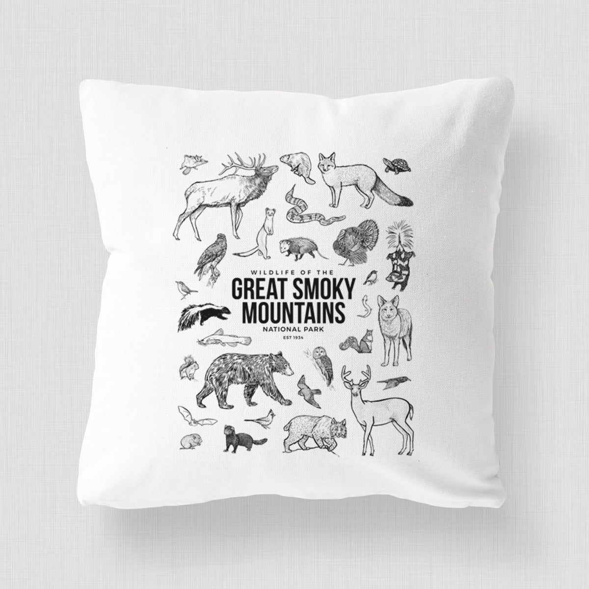 White pillow cover printed with a collection of black ink wildlife illustrations surrounding the words Great Smoky Mountains National Park.