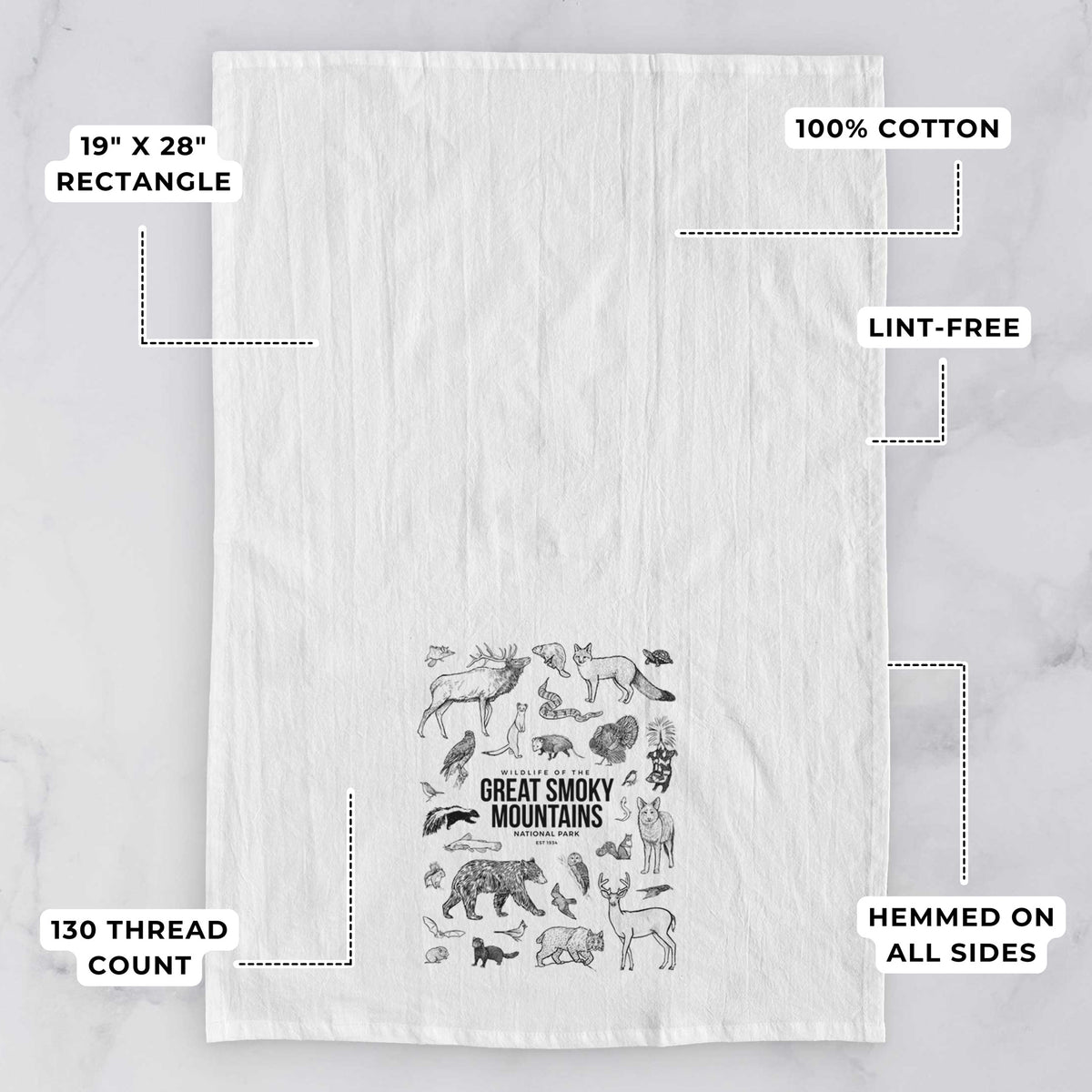 White tea towel printed with a collection of black ink wildlife illustrations surrounding the words Great Smoky Mountains National Park, with feature labels: 19 by 28 inch rectangle, 100% cotton, lint-free, 130 thread count, hemmed on all sides.