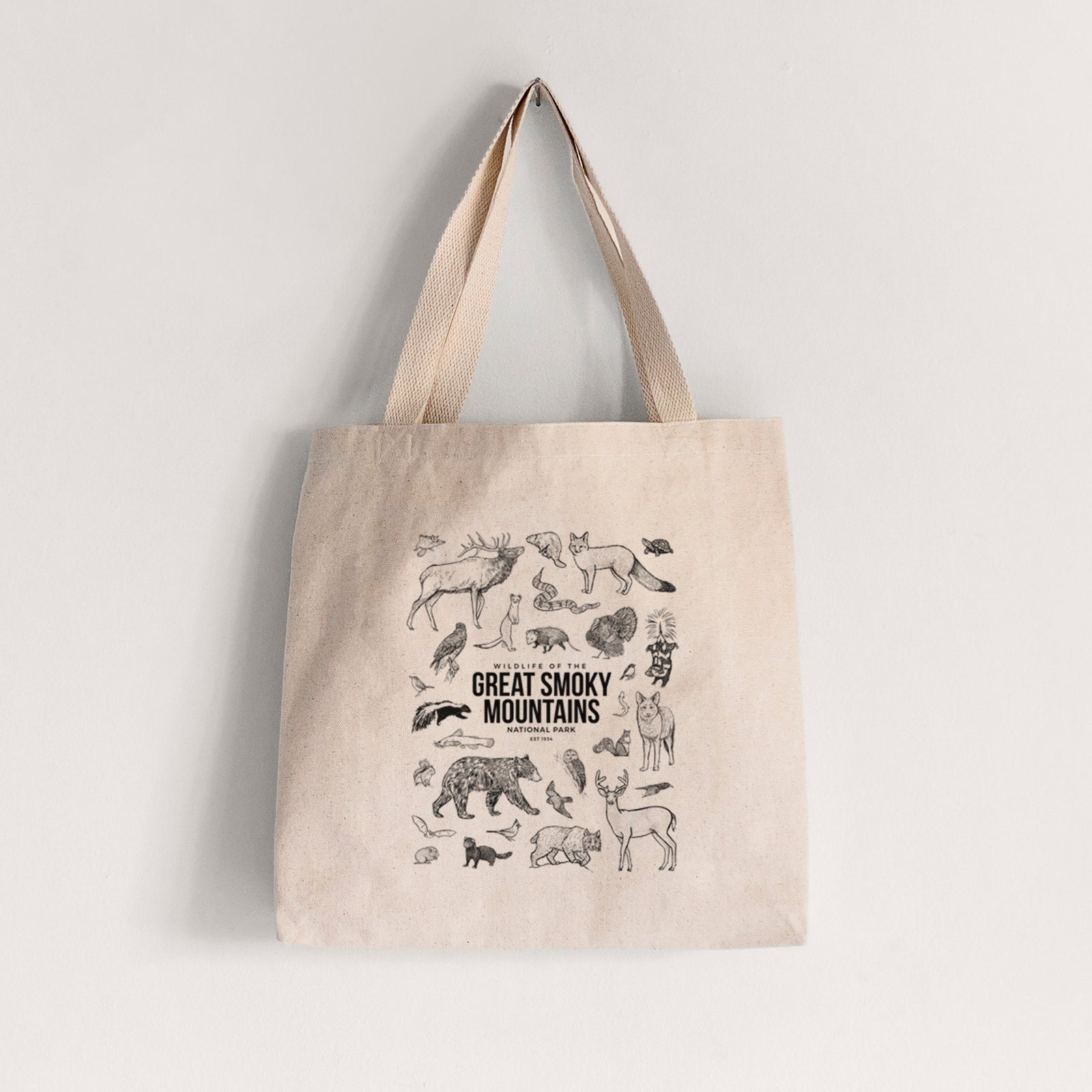 Natural canvas tote bag printed with a collection of black ink wildlife illustrations surrounding the words Great Smoky Mountains National Park.