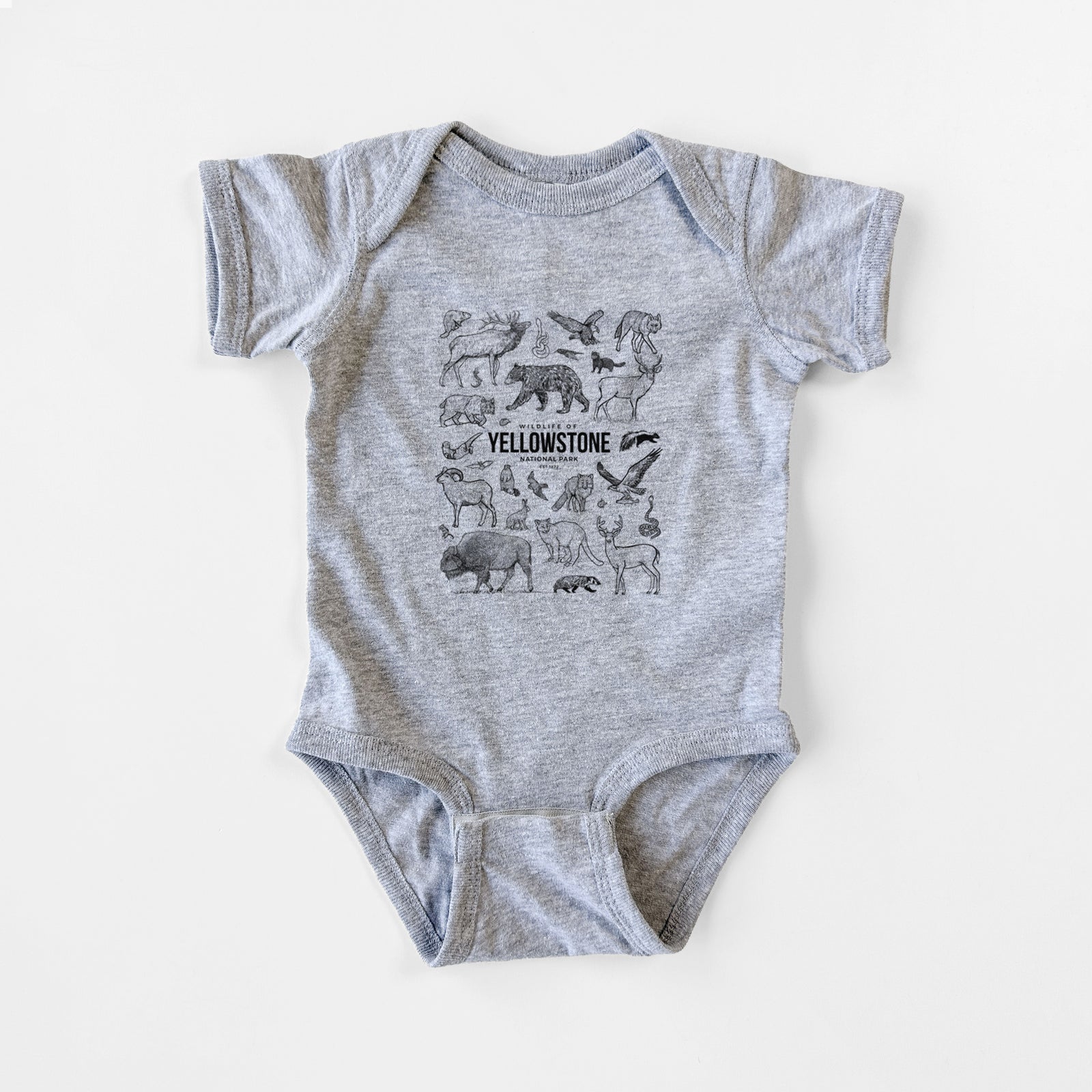 Grey baby bodysuit laid flat, printed with a collection of black ink wildlife illustrations surrounding the words Yellowstone National Park.