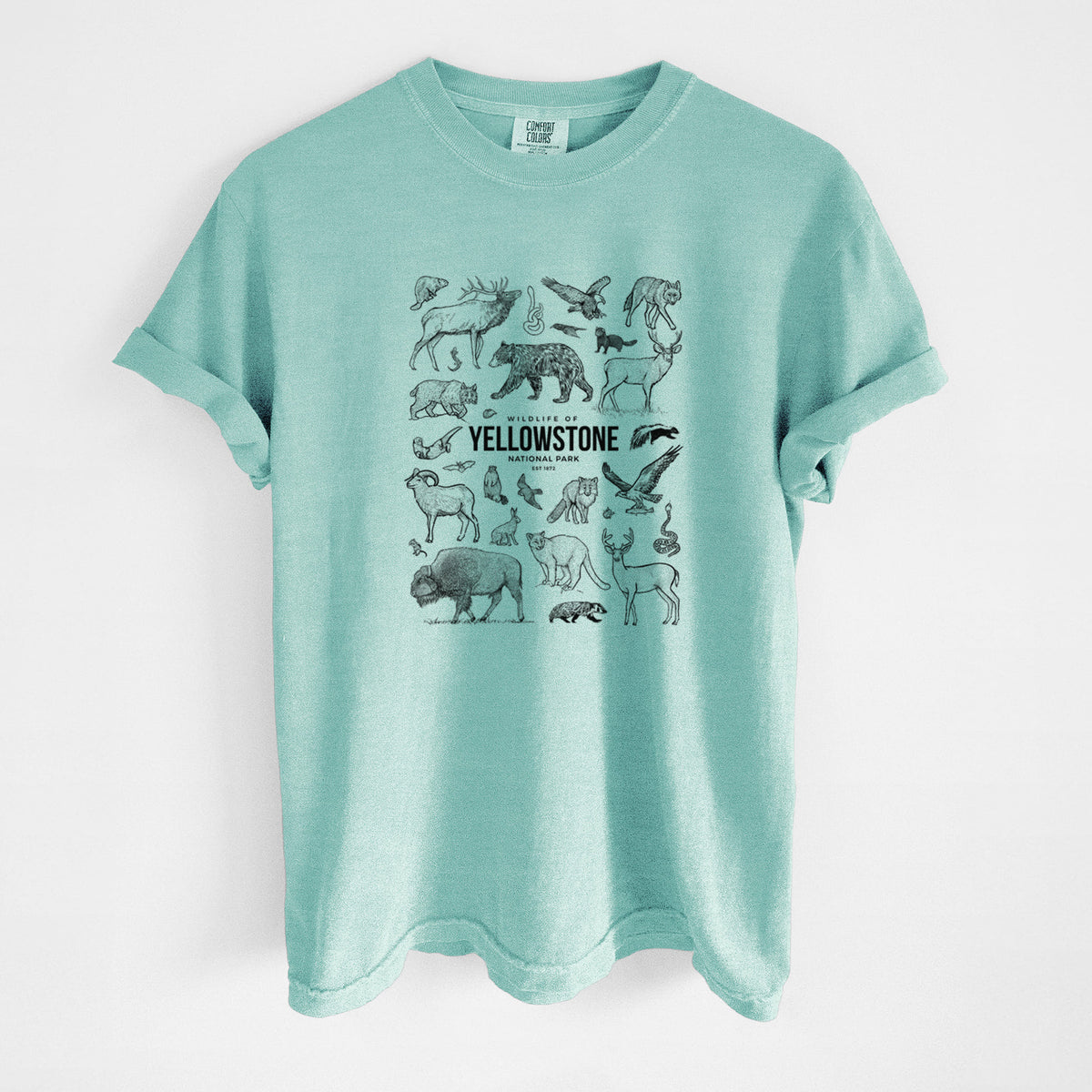 Chalky mint Comfort Colors t-shirt laid flat, printed with a collection of black ink wildlife illustrations surrounding the words Yellowstone National Park.