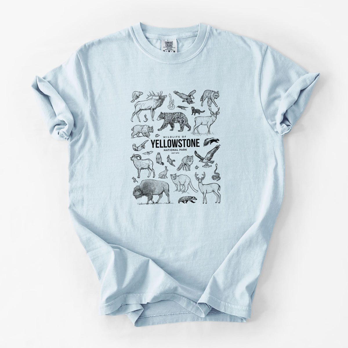 Chambray blue Comfort Colors t-shirt laid flat, printed with a collection of black ink wildlife illustrations surrounding the words Yellowstone National Park.