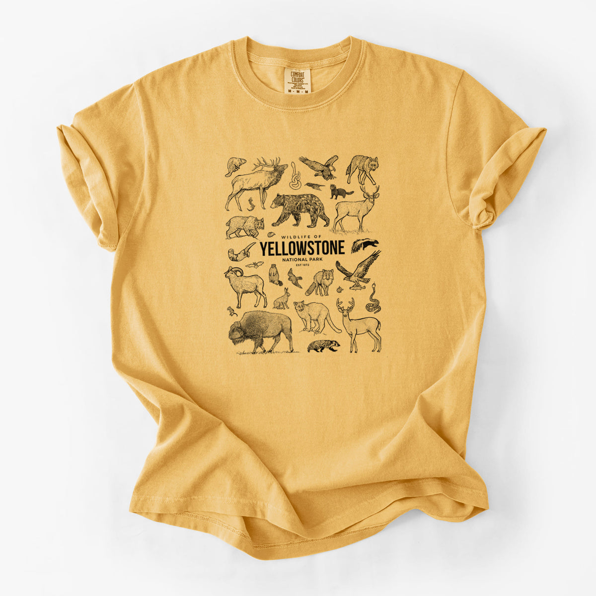 Golden wheat yellow Comfort Colors t-shirt laid flat, printed with a collection of black ink wildlife illustrations surrounding the words Yellowstone National Park.
