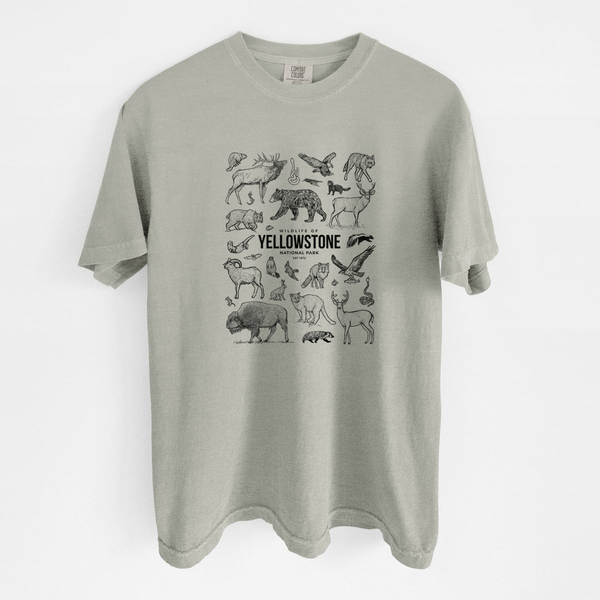 Sandstone beige Comfort Colors t-shirt laid flat, printed with a collection of black ink wildlife illustrations surrounding the words Yellowstone National Park.