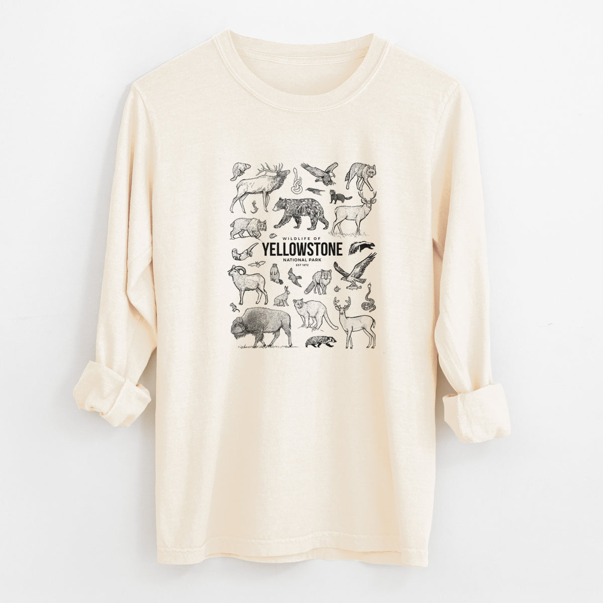 Ivory Comfort Colors long sleeve shirt laid flat with the cuffs rolled, printed with a collection of black ink wildlife illustrations surrounding the words Yellowstone National Park.