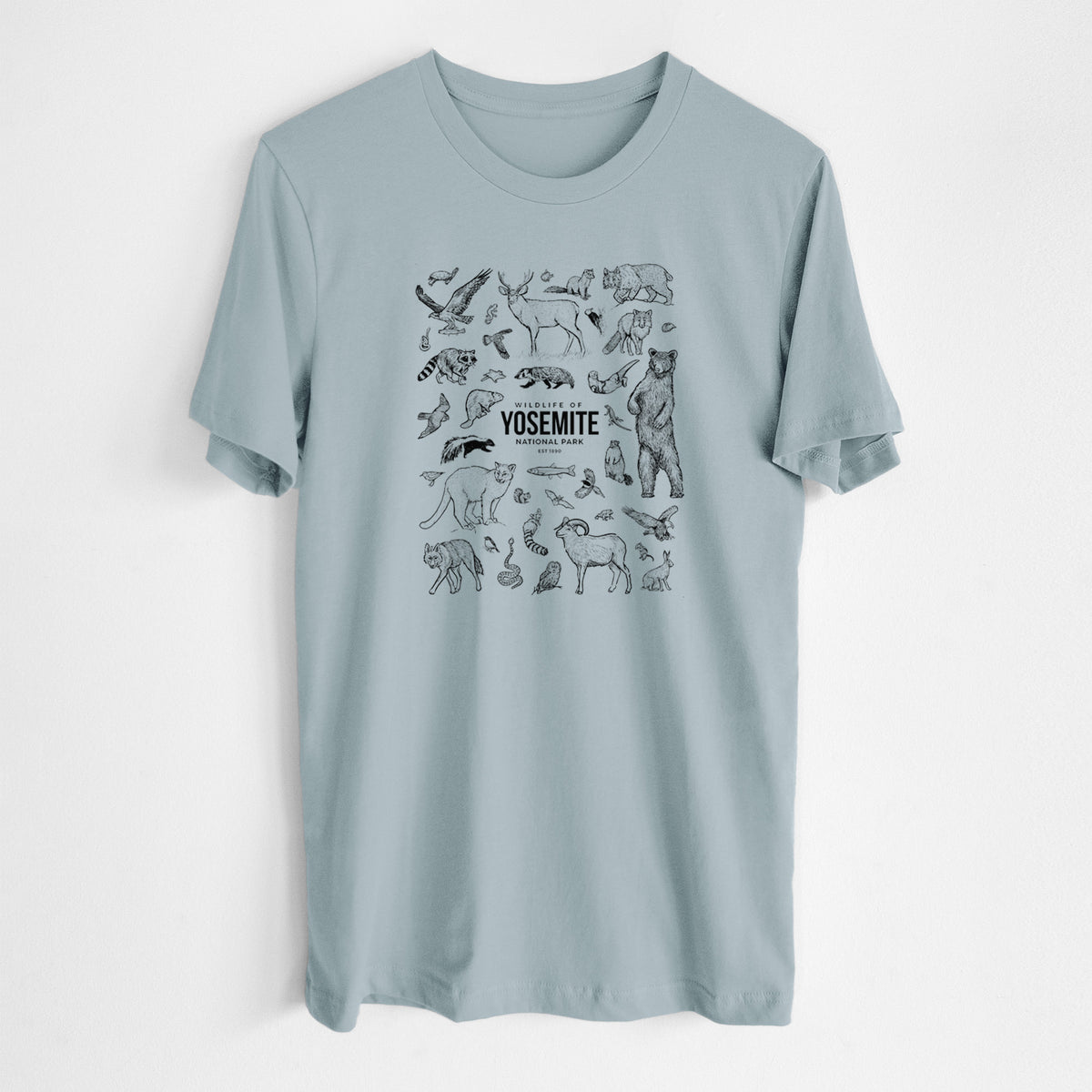 Vintage denim lightweight cotton t-shirt laid flat, printed with a collection of black ink wildlife illustrations surrounding the words Yosemite National Park.