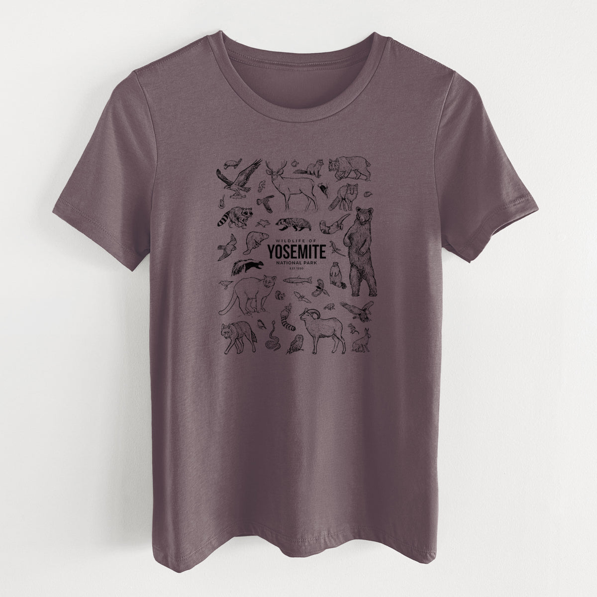 Purple storm women's relaxed fit cotton t-shirt laid flat, printed with a collection of black ink wildlife illustrations surrounding the words Yosemite National Park.