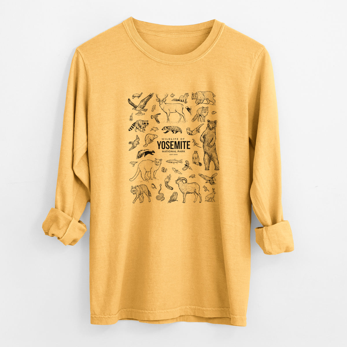 Golden wheat yellow Comfort Colors long sleeve shirt laid flat with the cuffs rolled, printed with a collection of black ink wildlife illustrations surrounding the words Yosemite National Park.