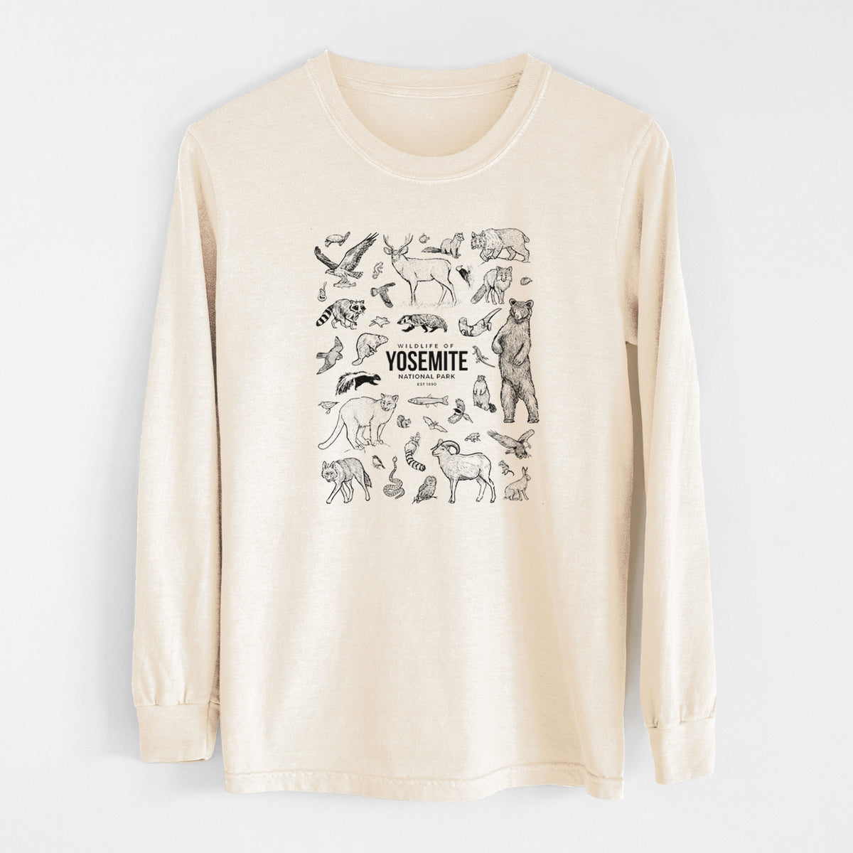 Ivory Comfort Colors long sleeve shirt laid flat, printed with a collection of black ink wildlife illustrations surrounding the words Yosemite National Park.