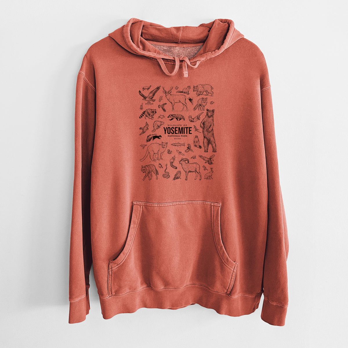 Amber orange pigment dyed hoodie laid flat, printed with a collection of black ink wildlife illustrations surrounding the words Yosemite National Park.