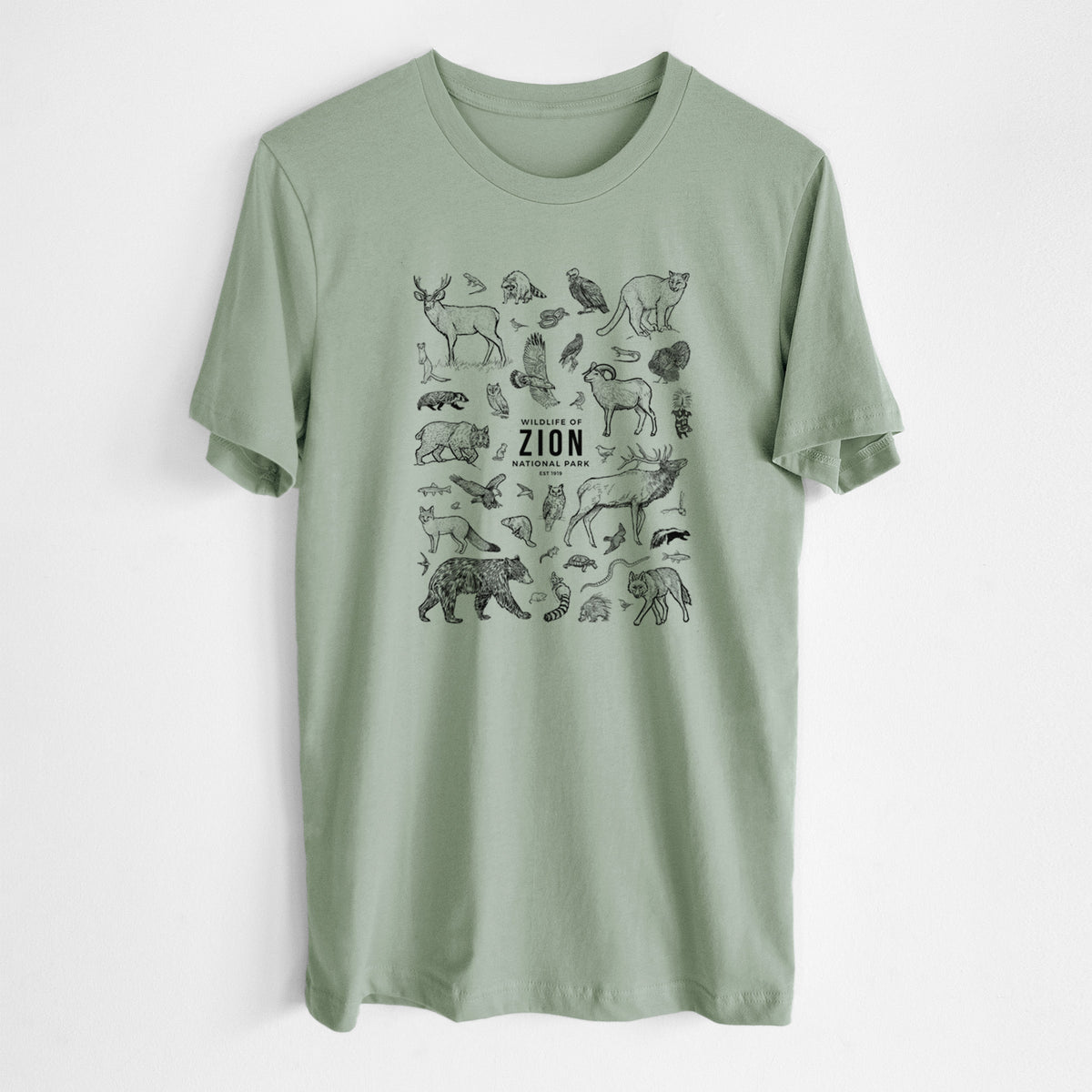 Sage green lightweight cotton t-shirt laid flat, printed with a collection of black ink wildlife illustrations surrounding the words Zion National Park.