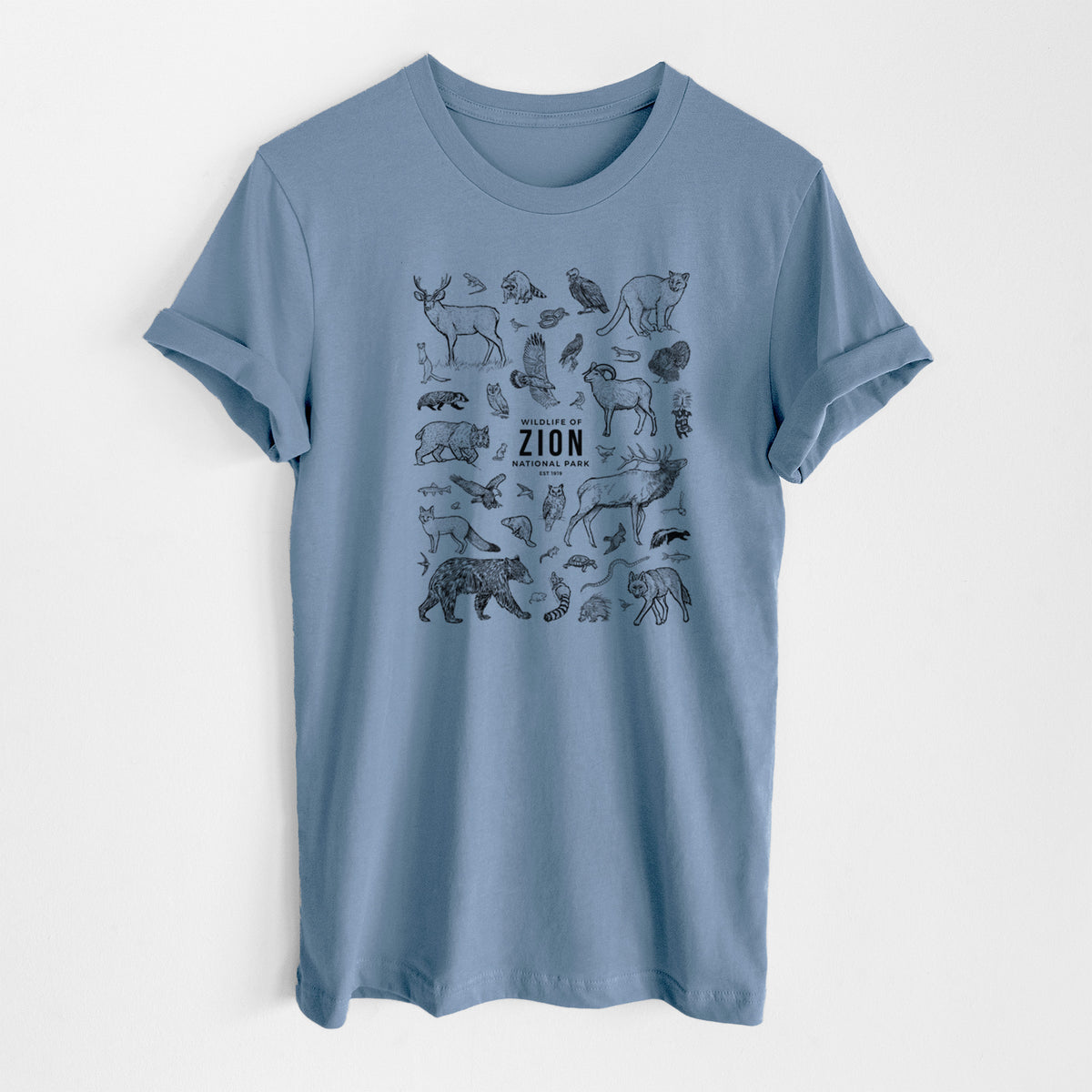 Steel blue lightweight cotton t-shirt laid flat, printed with a collection of black ink wildlife illustrations surrounding the words Zion National Park.
