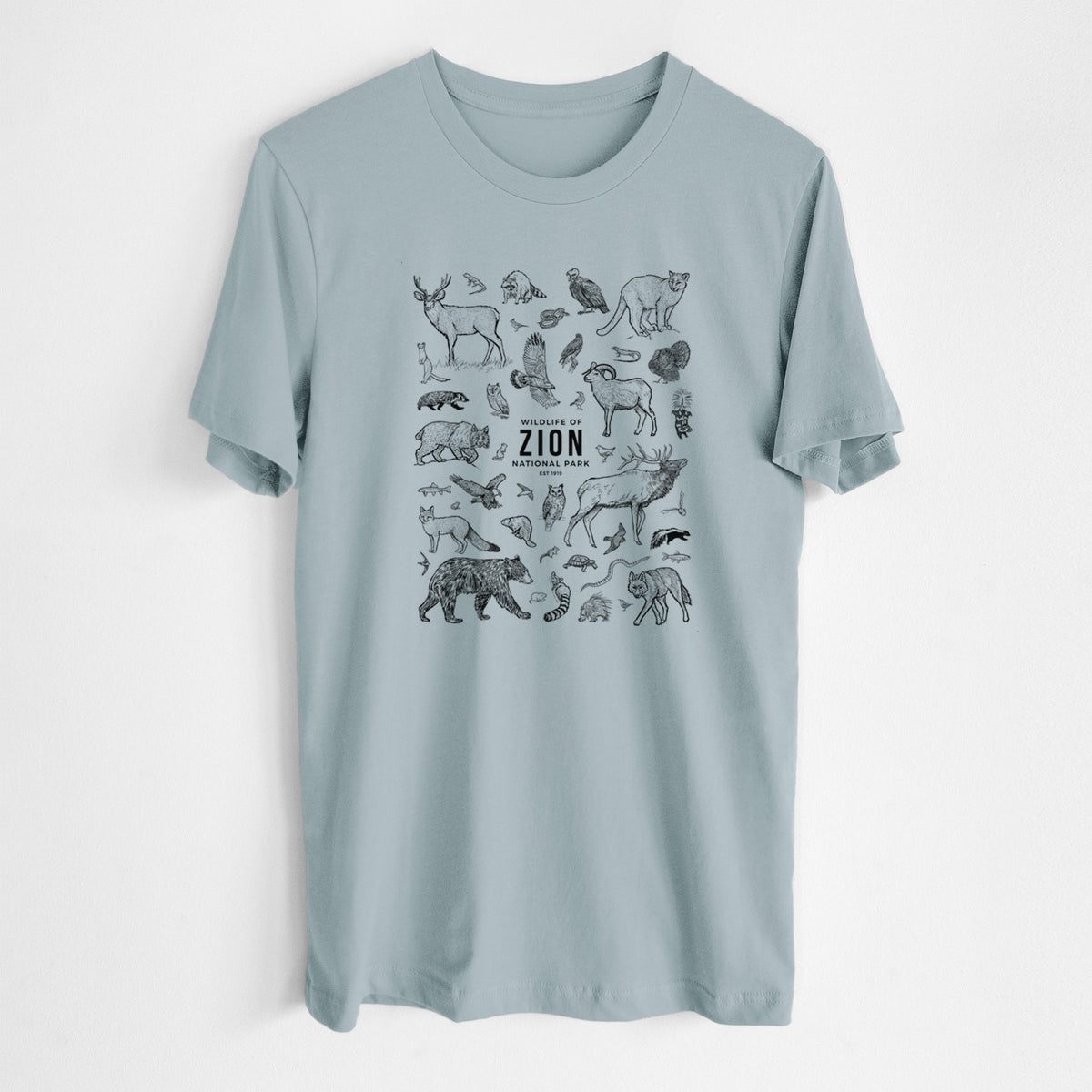 Vintage denim lightweight cotton t-shirt laid flat, printed with a collection of black ink wildlife illustrations surrounding the words Zion National Park.