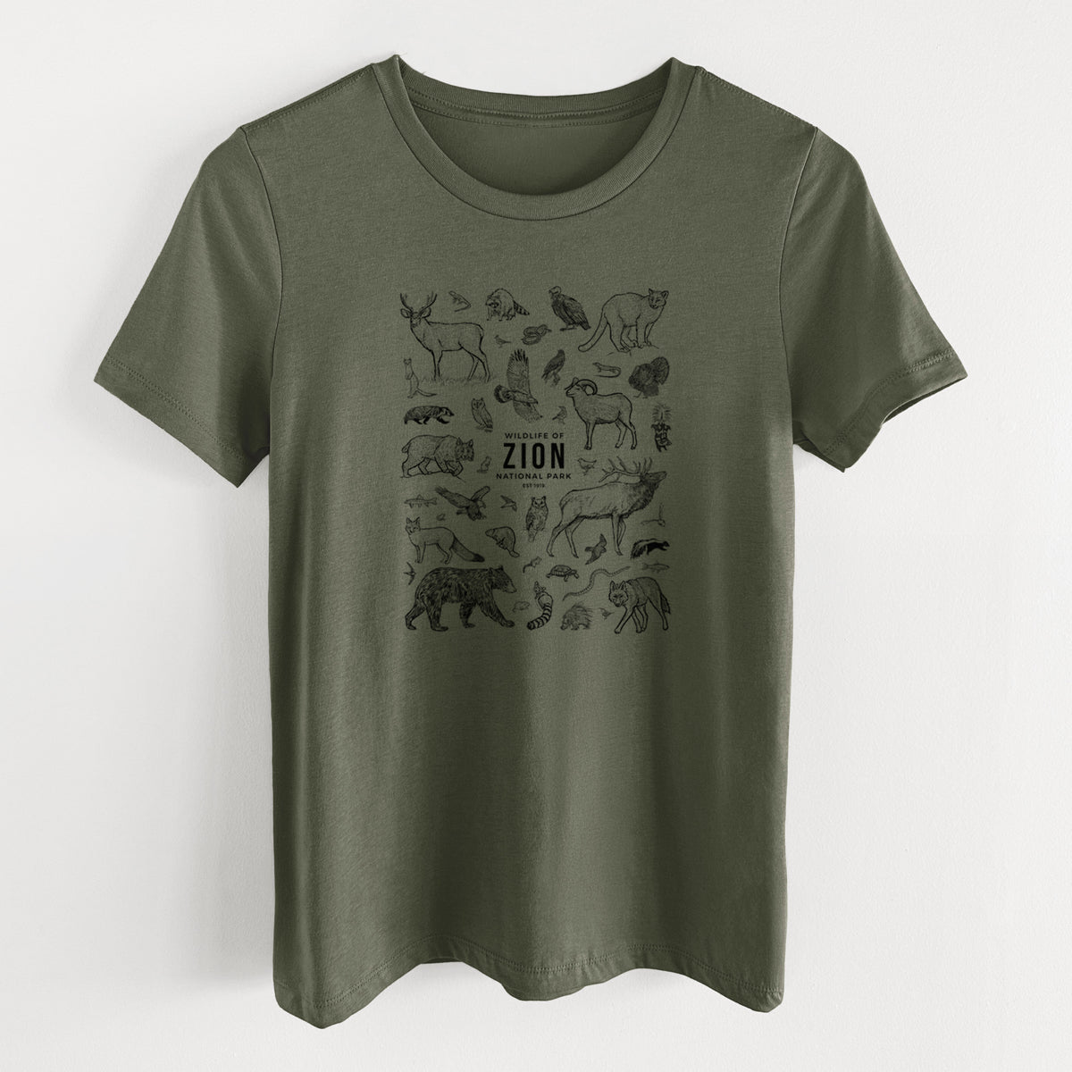 Military green women's relaxed fit cotton t-shirt laid flat, printed with a collection of black ink wildlife illustrations surrounding the words Zion National Park.