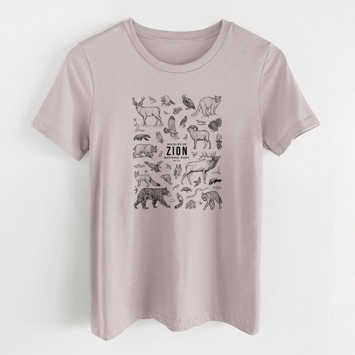 Pink gravel women's relaxed fit cotton t-shirt laid flat, printed with a collection of black ink wildlife illustrations surrounding the words Zion National Park.