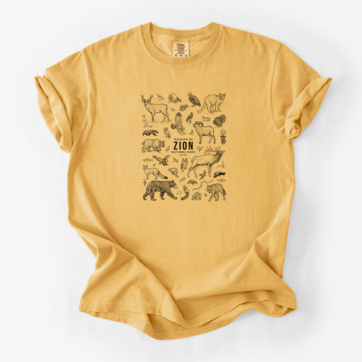 Golden wheat yellow Comfort Colors t-shirt laid flat, printed with a collection of black ink wildlife illustrations surrounding the words Zion National Park.