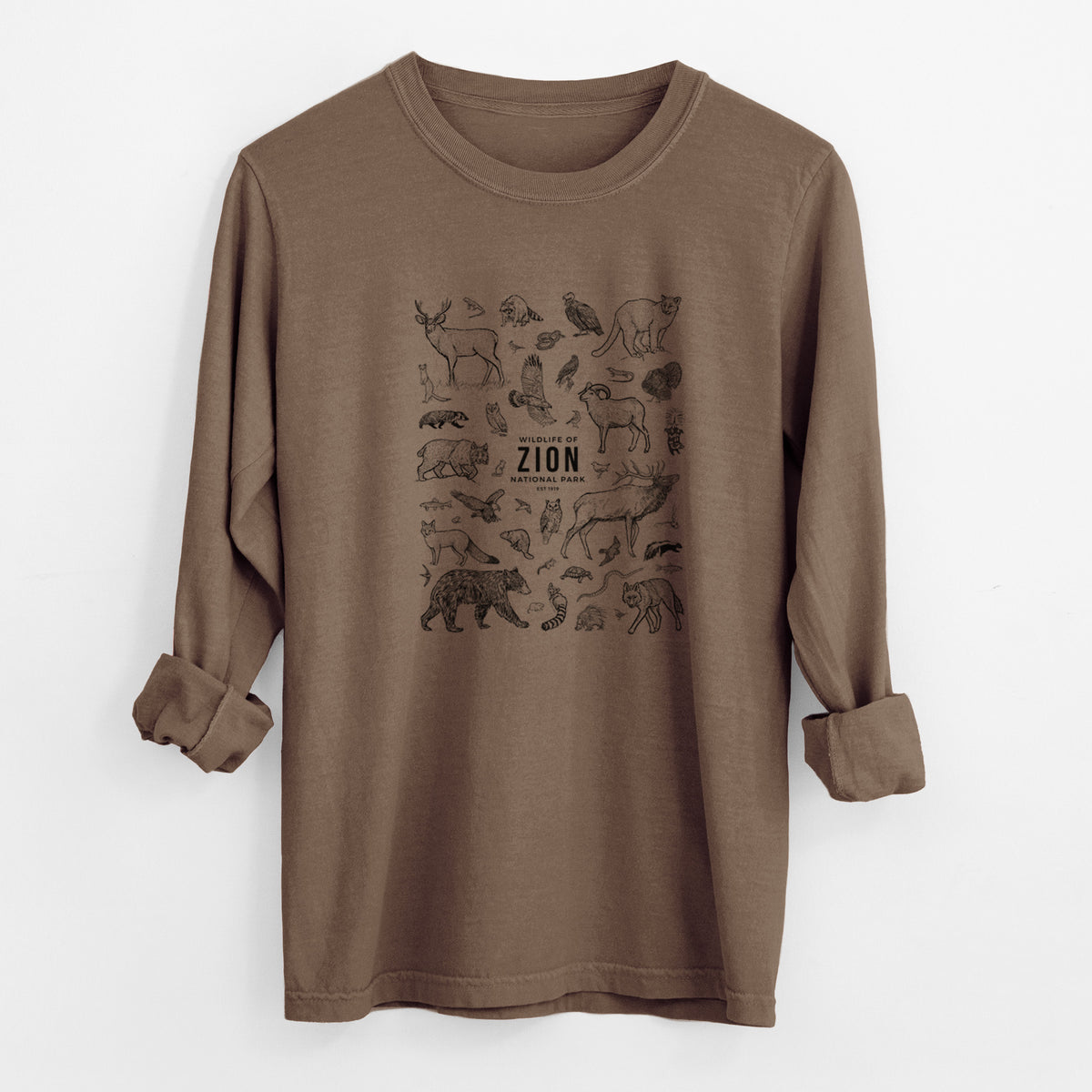 Espresso brown Comfort Colors long sleeve shirt laid flat with the cuffs rolled, printed with a collection of black ink wildlife illustrations surrounding the words Zion National Park.