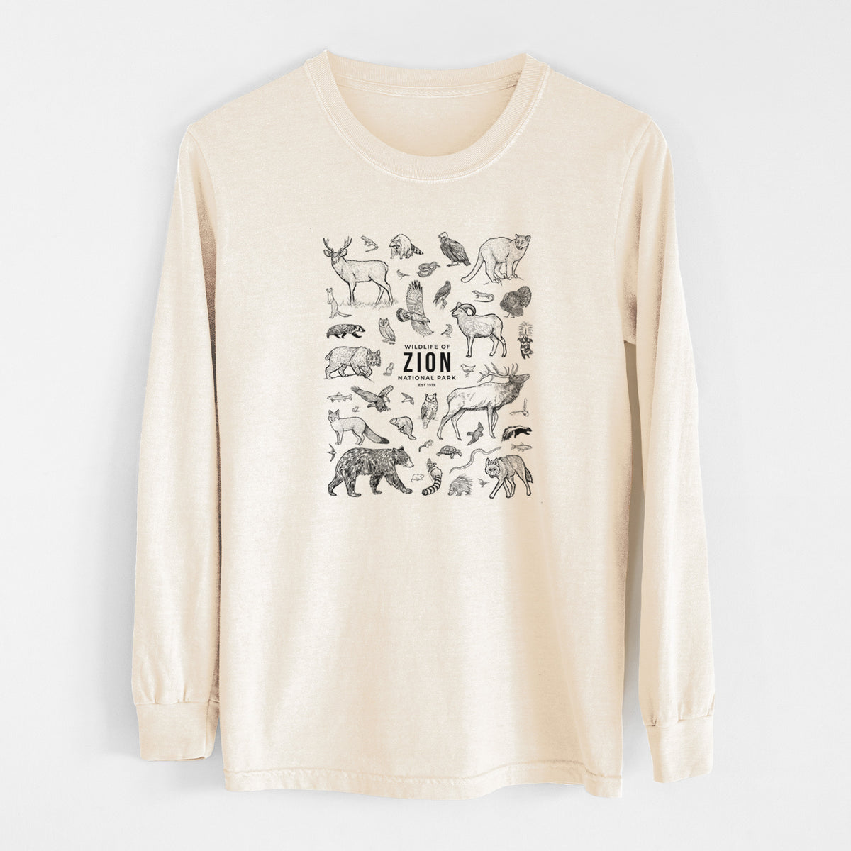 Ivory Comfort Colors long sleeve shirt laid flat, printed with a collection of black ink wildlife illustrations surrounding the words Zion National Park.
