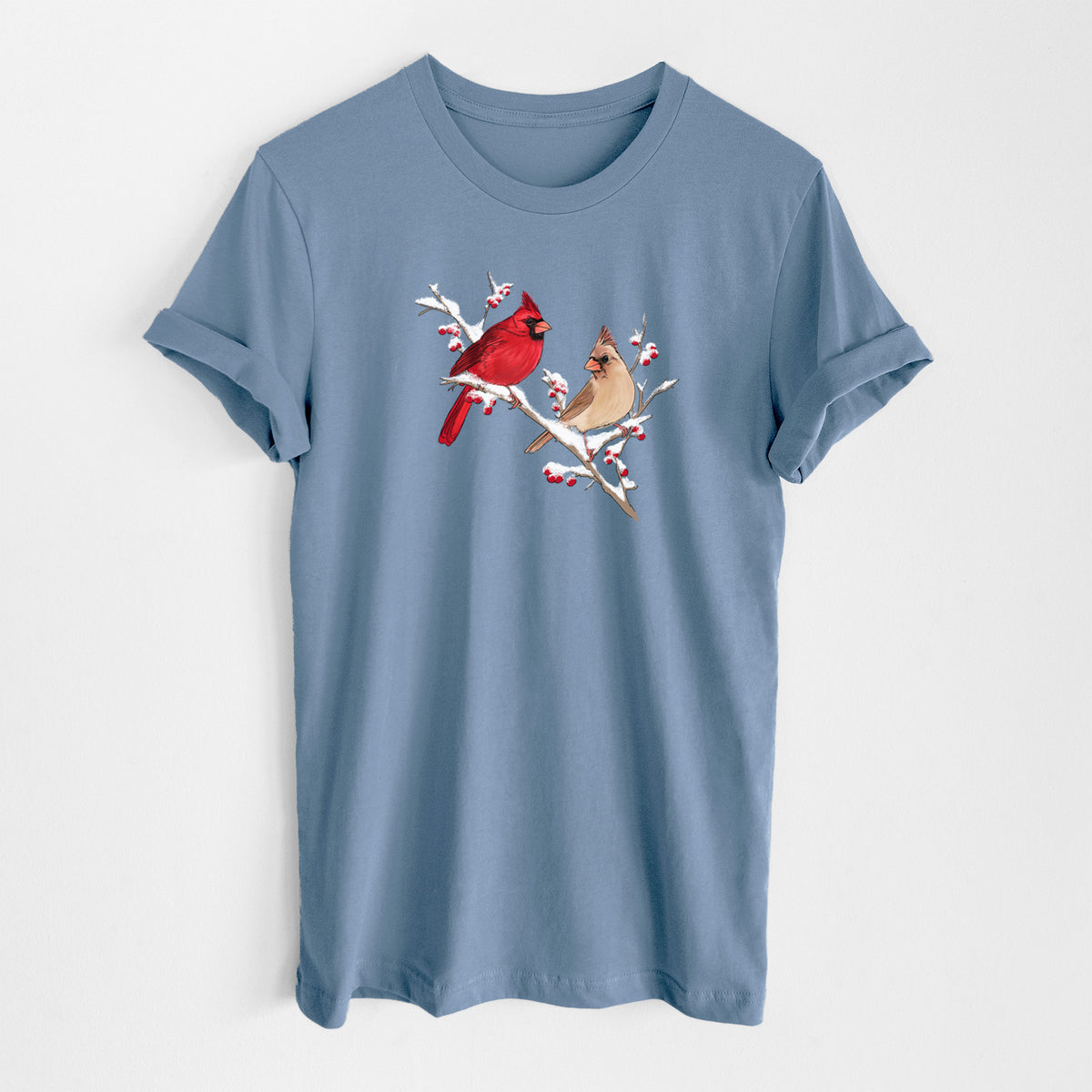 Steel blue lightweight cotton t-shirt laid flat, printed with a full-color illustration of a male and female northern cardinal perched on a snowy branch with red berries.