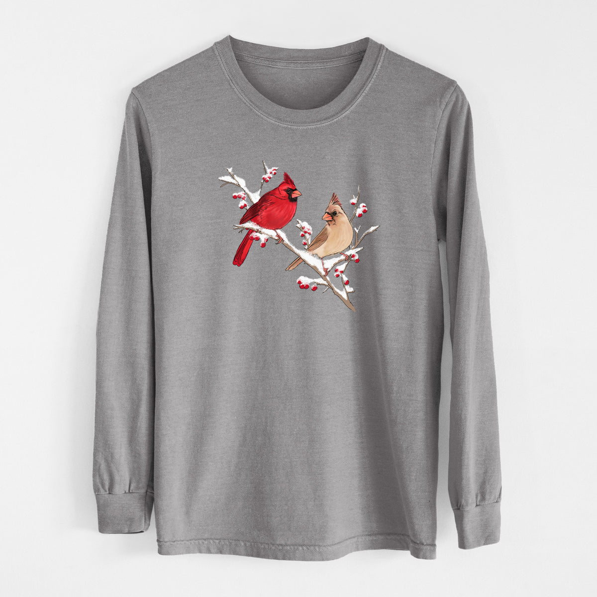 Grey Comfort Colors long sleeve shirt laid flat, printed with a full-color illustration of a male and female northern cardinal perched on a snowy branch with red berries.