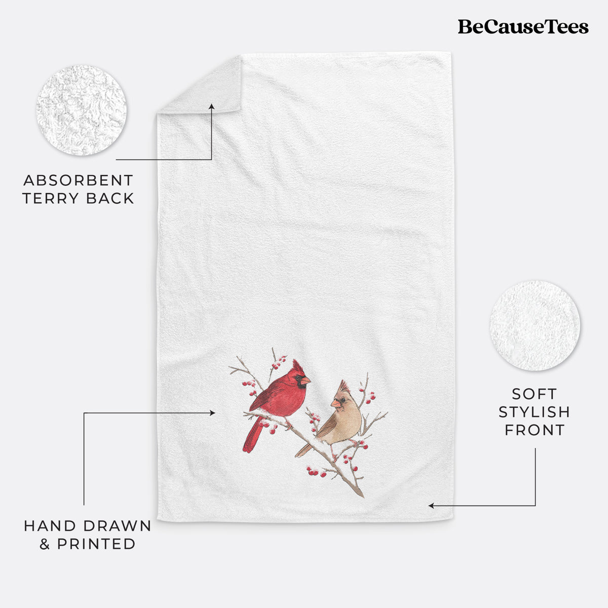 White hand towel printed with a full-color illustration of a male and female northern cardinal perched on a snowy branch with red berries.
