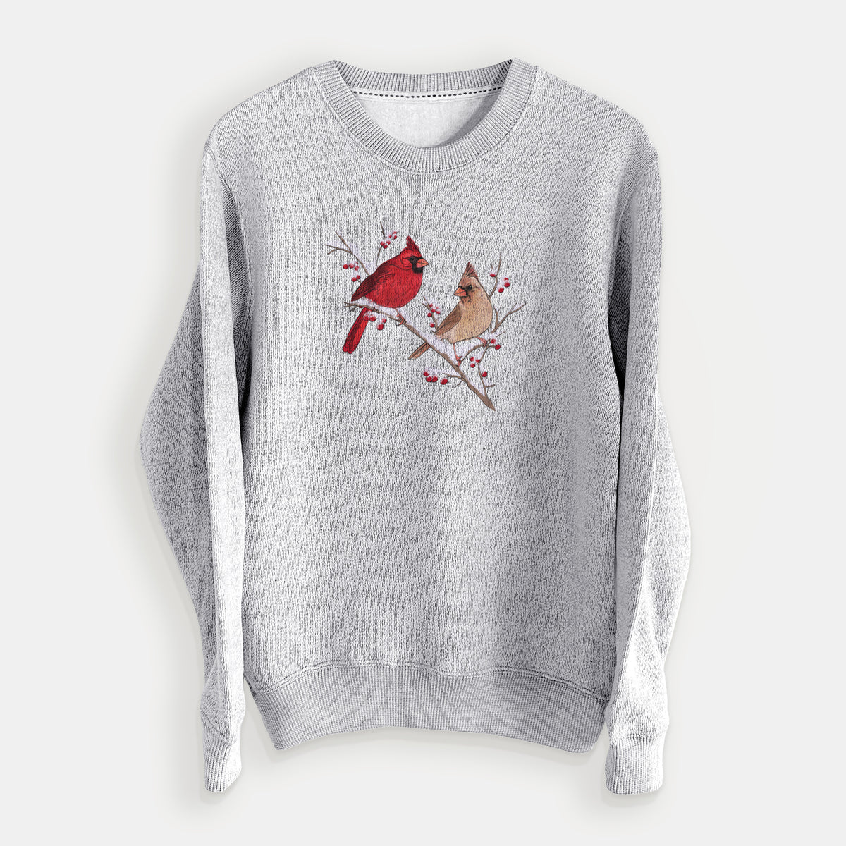 Salt and pepper knit sweatshirt laid flat, printed with a full-color illustration of a male and female northern cardinal perched on a snowy branch with red berries.