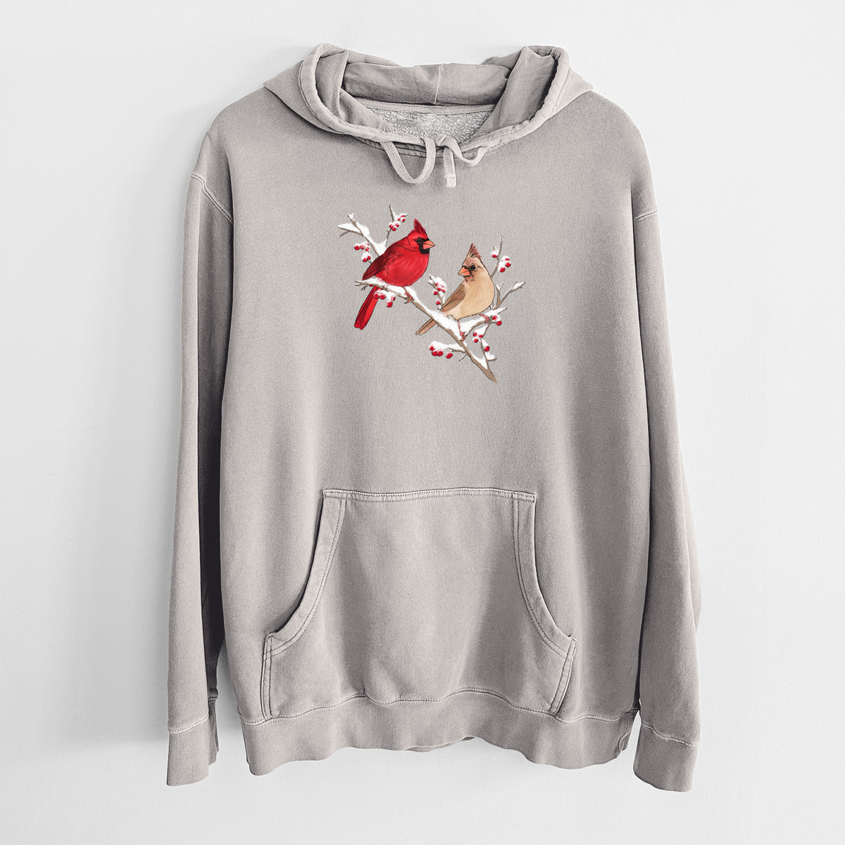 Cement grey pigment dyed hoodie laid flat, printed with a full-color illustration of a male and female northern cardinal perched on a snowy branch with red berries.