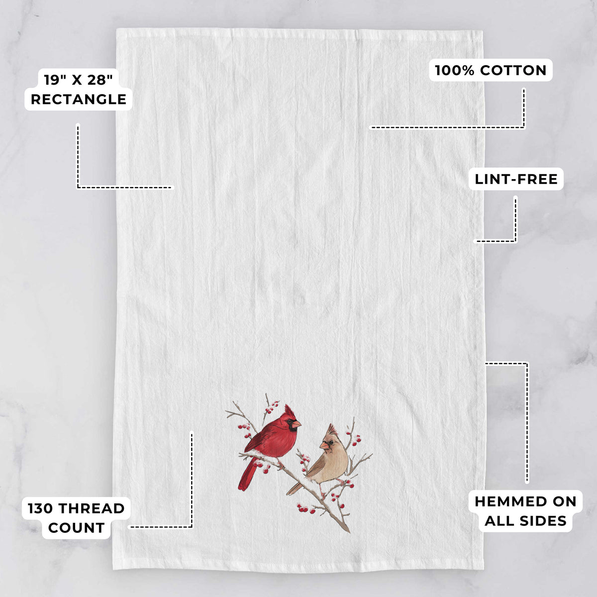 White tea towel printed with a full-color illustration of a male and female northern cardinal perched on a snowy branch with red berries, with feature labels: 19 by 28 inch rectangle, 100% cotton, lint-free, 130 thread count, hemmed on all sides.