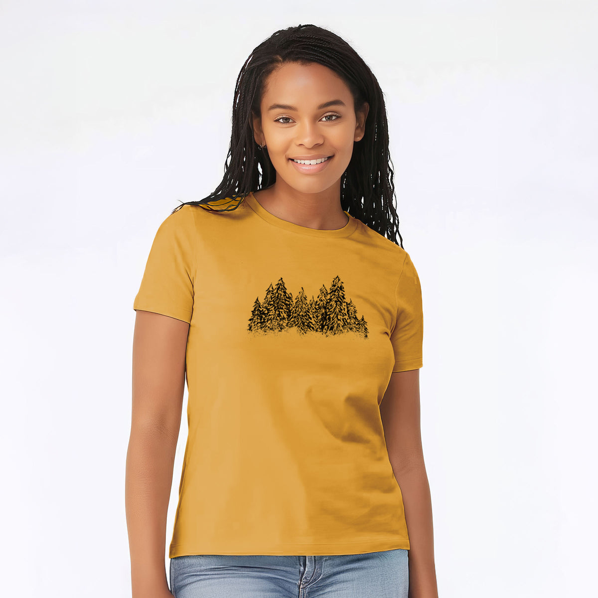 Woman wearing a mustard yellow women's relaxed fit cotton t-shirt printed with a black ink illustration of a row of snow-dusted evergreen trees.