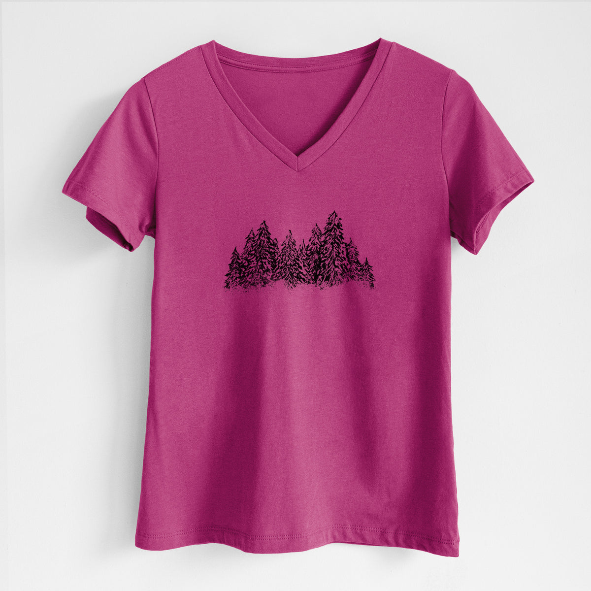 Berry pink women's relaxed fit cotton V-neck t-shirt laid flat, printed with a black ink illustration of a row of snow-dusted evergreen trees.