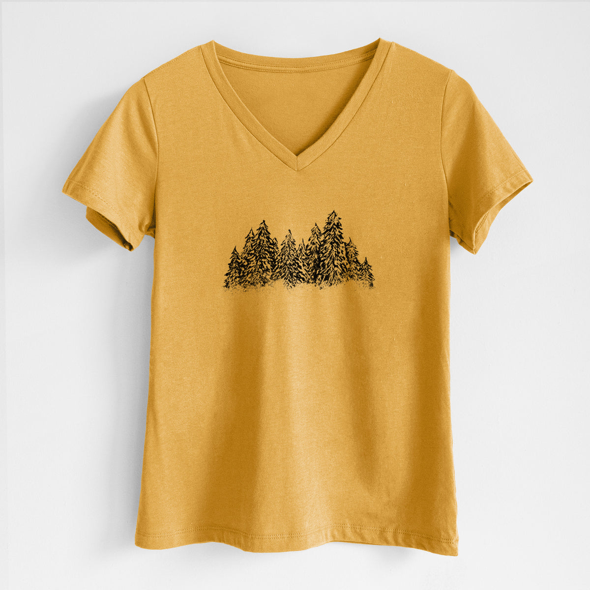 Honeycomb yellow women's relaxed fit cotton V-neck t-shirt laid flat, printed with a black ink illustration of a row of snow-dusted evergreen trees.