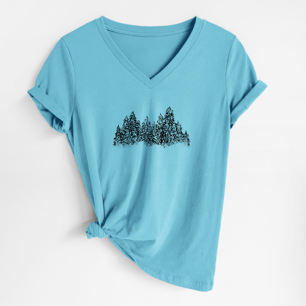 Turquoise women's relaxed fit cotton V-neck t-shirt laid flat, printed with a black ink illustration of a row of snow-dusted evergreen trees.