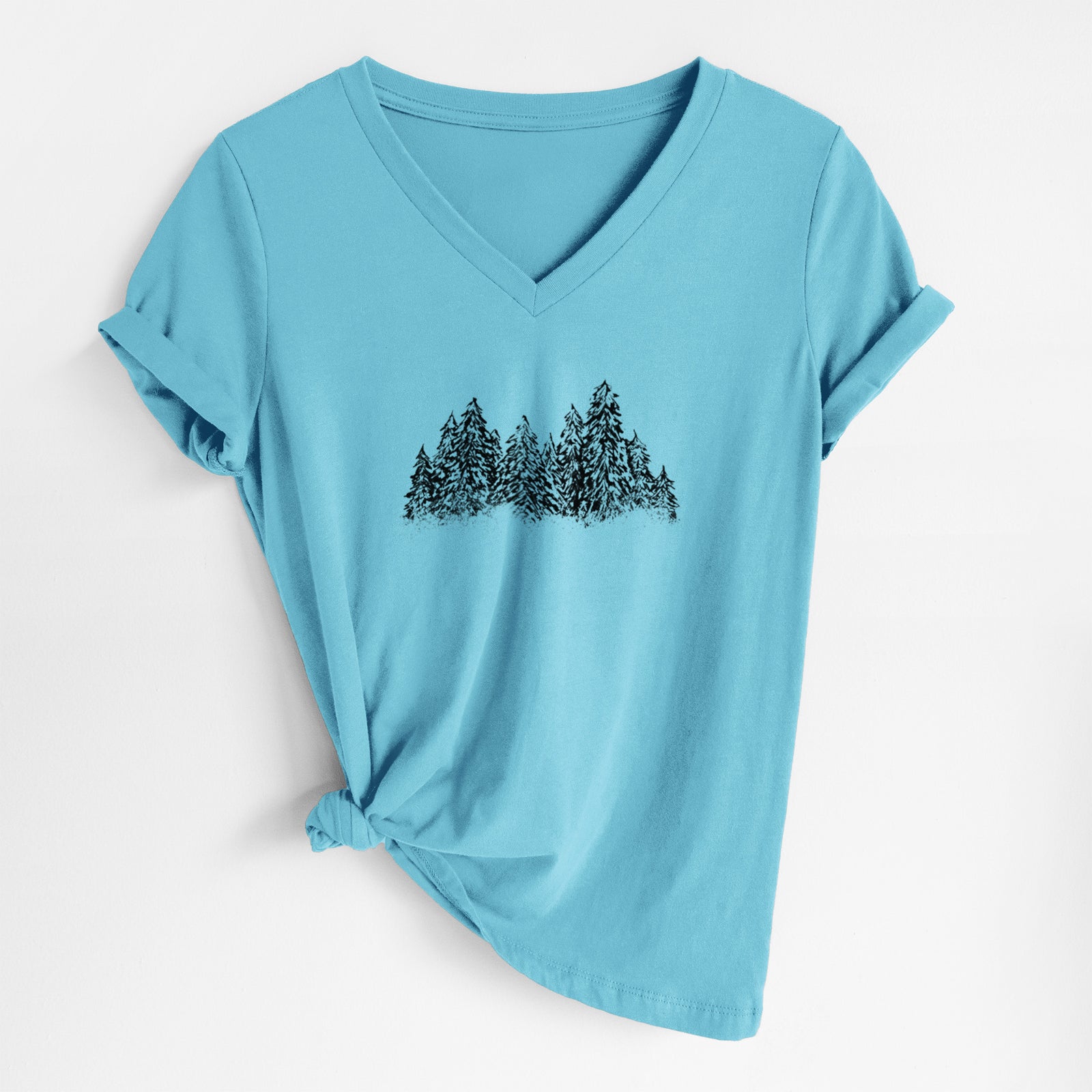 Turquoise women's relaxed fit cotton V-neck t-shirt laid flat, printed with a black ink illustration of a row of snow-dusted evergreen trees.