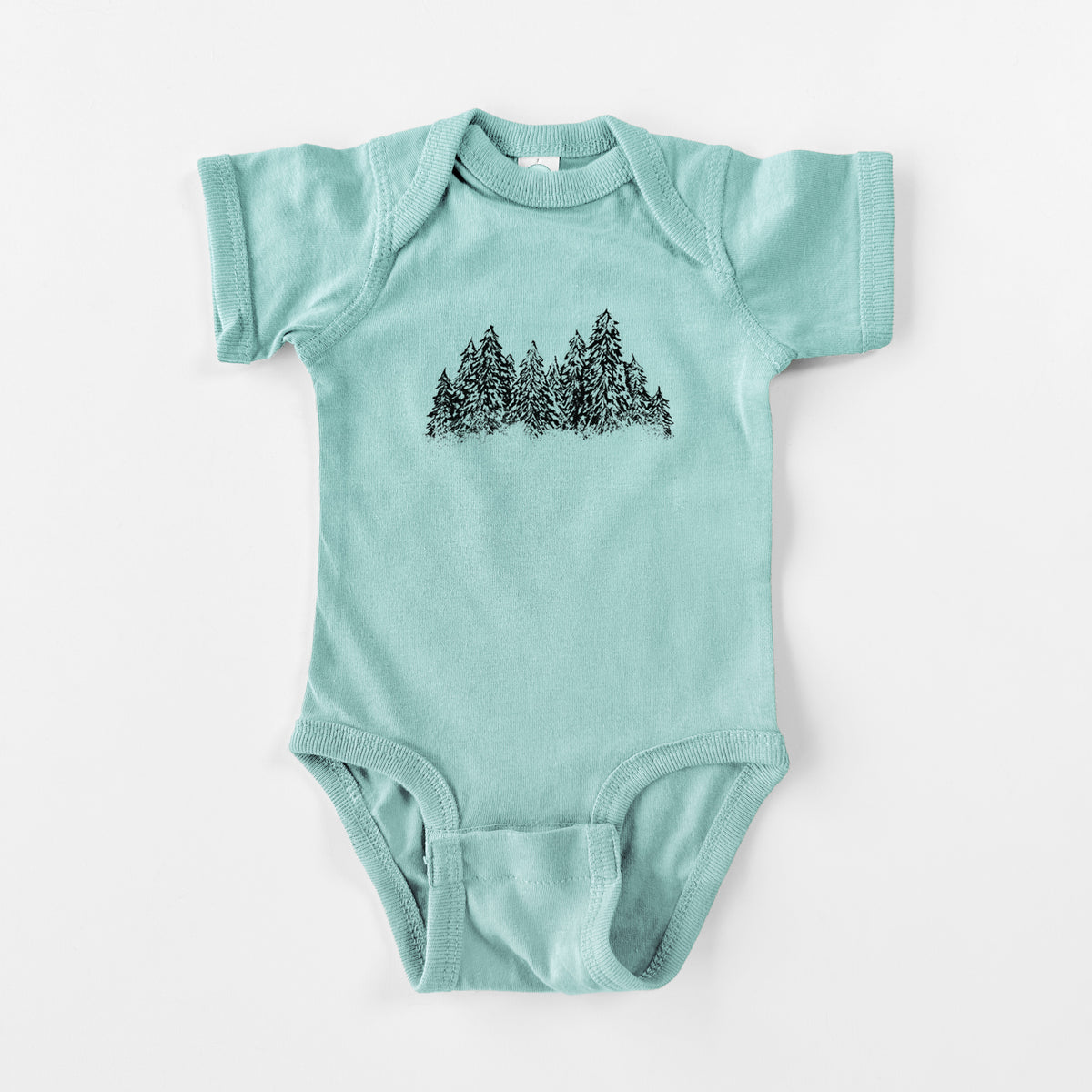 Saltwater baby bodysuit laid flat, printed with a black ink illustration of a row of snow-dusted evergreen trees.