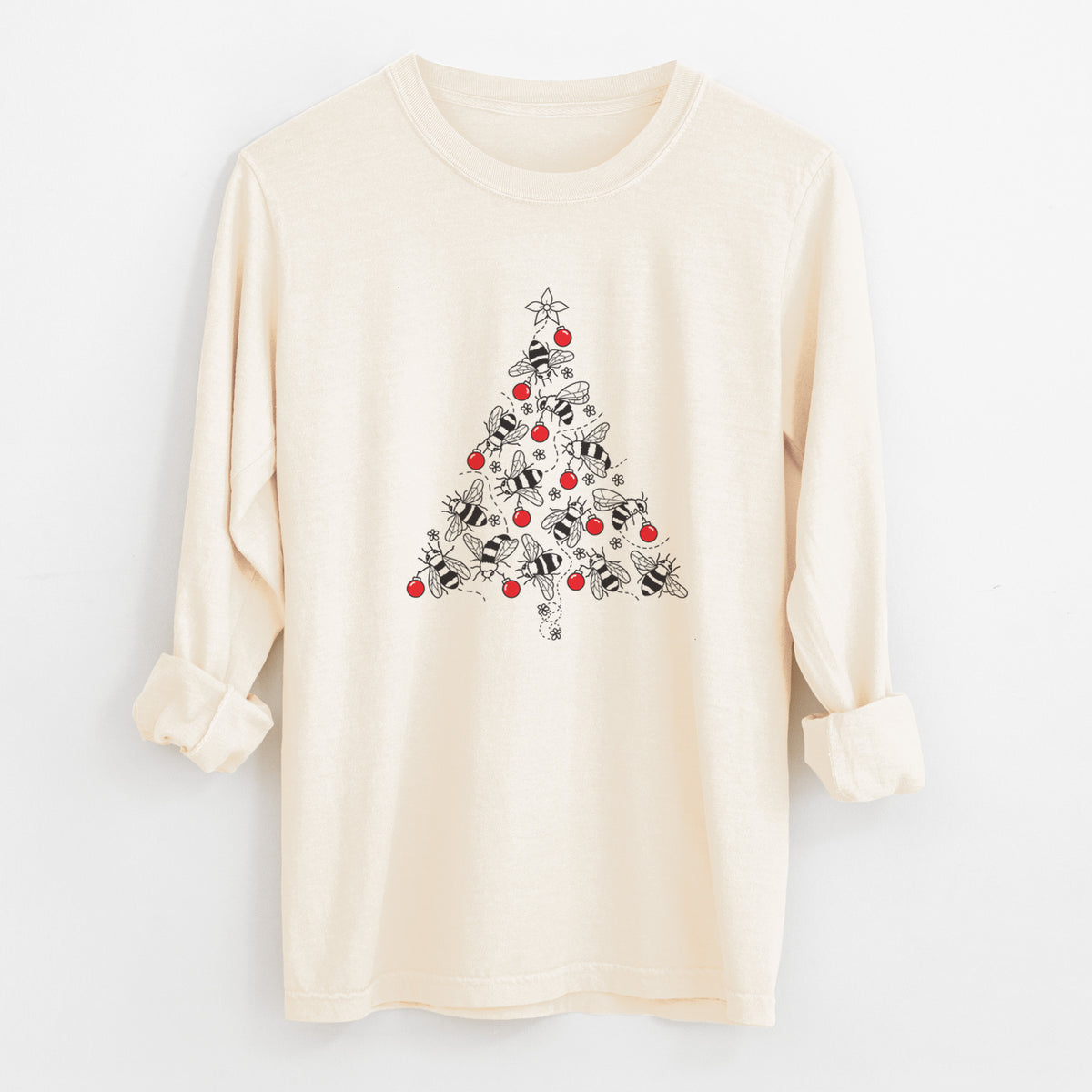 Ivory Comfort Colors long sleeve shirt laid flat with the cuffs rolled, printed with a Christmas tree made of black ink bees with red ornaments and a star on top.