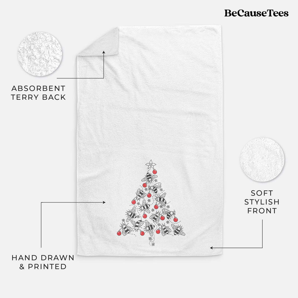 White hand towel printed with a Christmas tree made of black ink bees with red ornaments and a star on top.