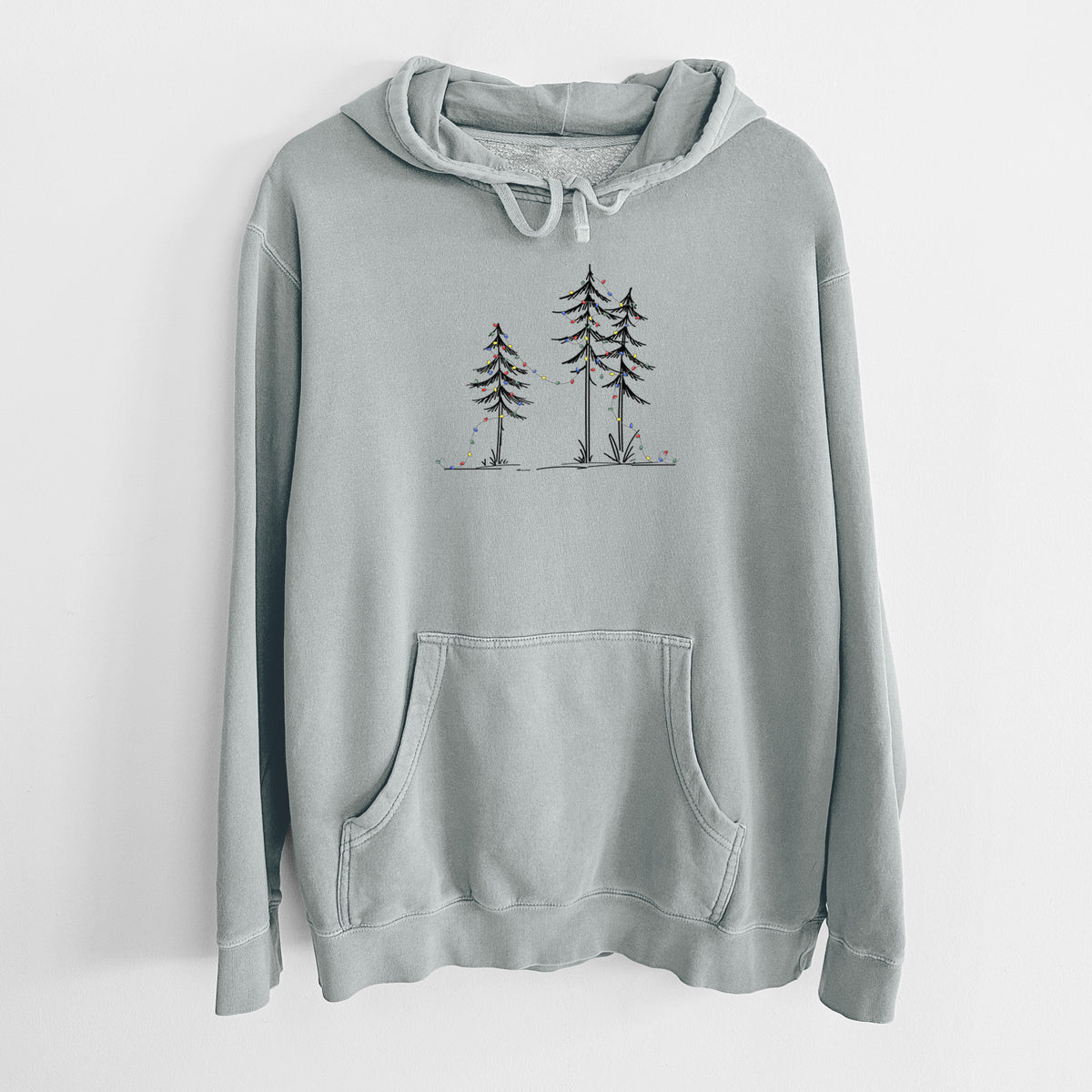 Sage green pigment dyed hoodie laid flat, printed with three slender black ink pine trees strung with a garland of multicolored holiday lights.