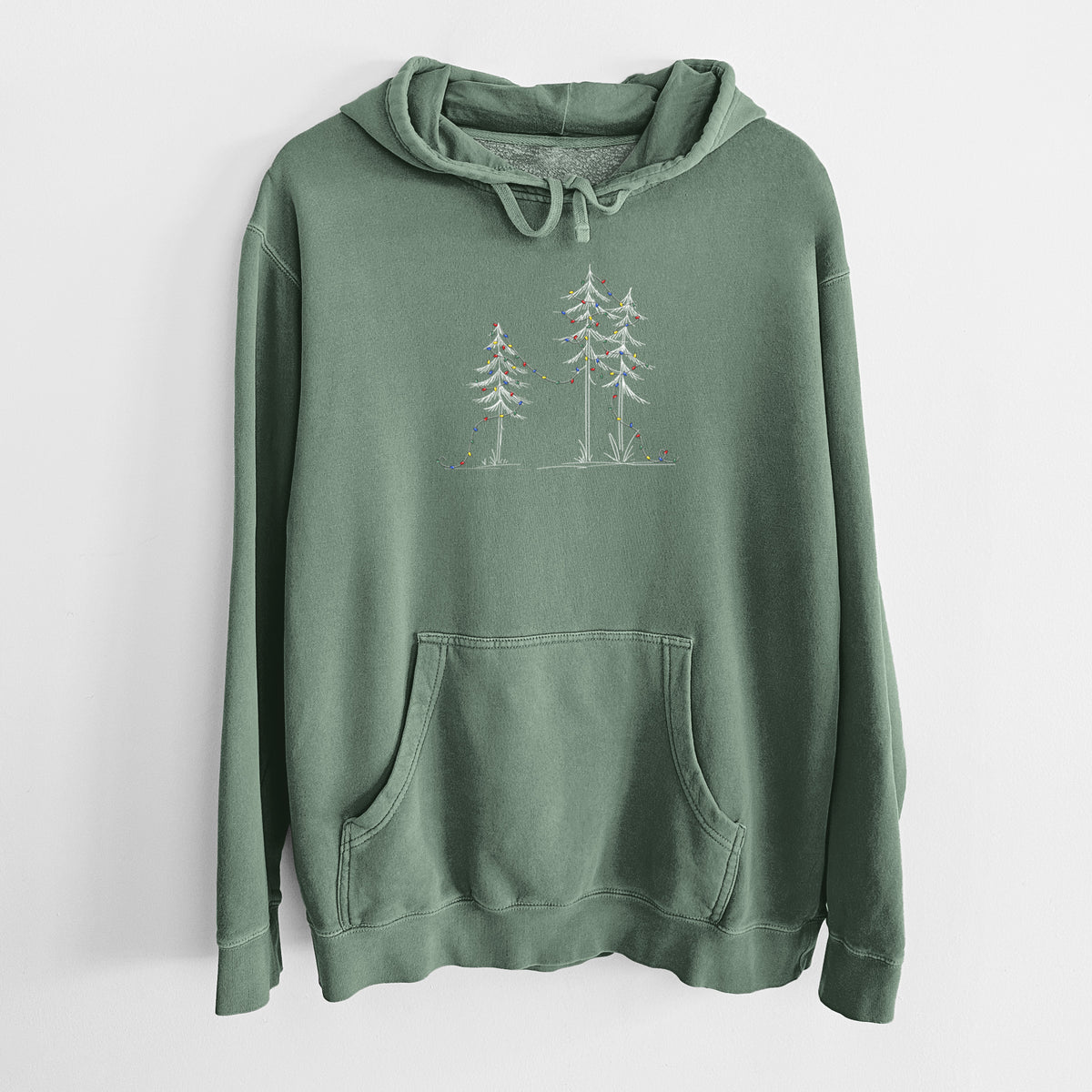 Alpine green pigment dyed hoodie laid flat, printed with three slender white ink pine trees strung with a garland of multicolored holiday lights.