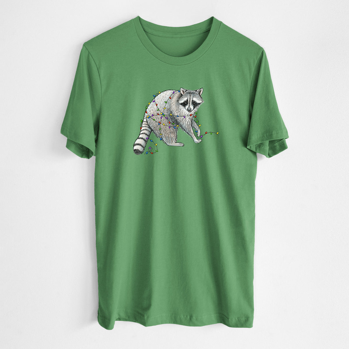 Leaf green lightweight cotton t-shirt laid flat, printed with a black ink raccoon tangled in a string of colorful holiday lights.