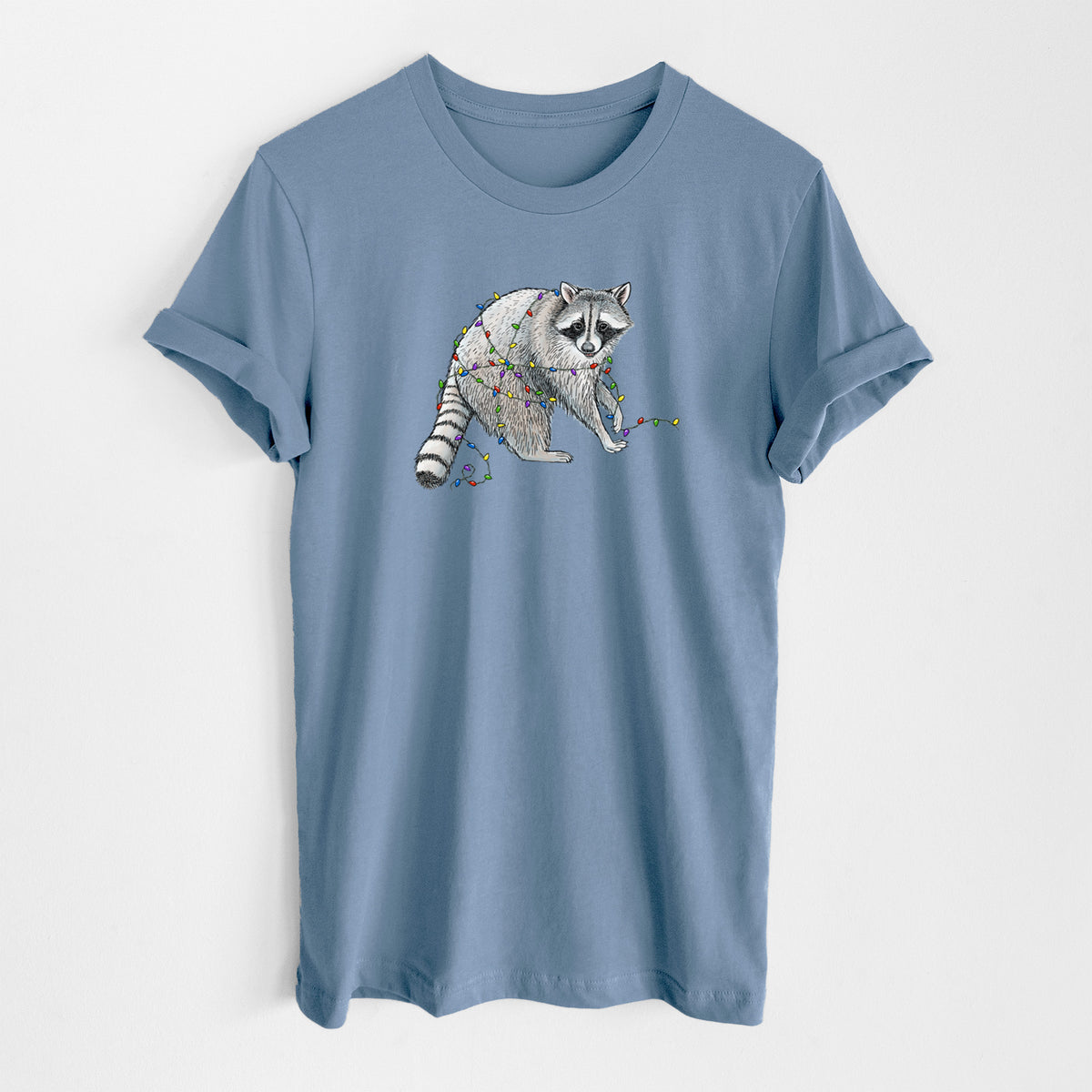 Steel blue lightweight cotton t-shirt laid flat, printed with a black ink raccoon tangled in a string of colorful holiday lights.