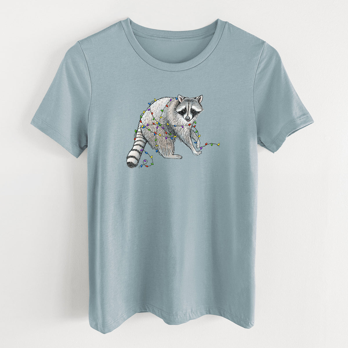 Vintage denim women's relaxed fit cotton t-shirt laid flat, printed with a black ink raccoon tangled in a string of colorful holiday lights.