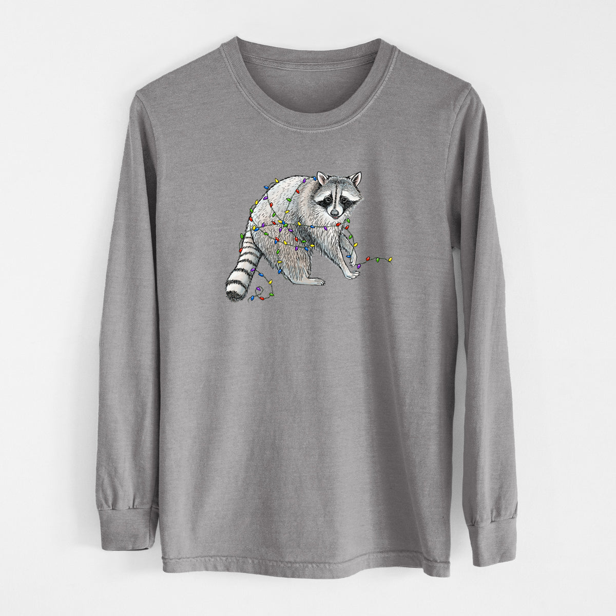 Grey Comfort Colors long sleeve shirt laid flat, printed with a black ink raccoon tangled in a string of colorful holiday lights.